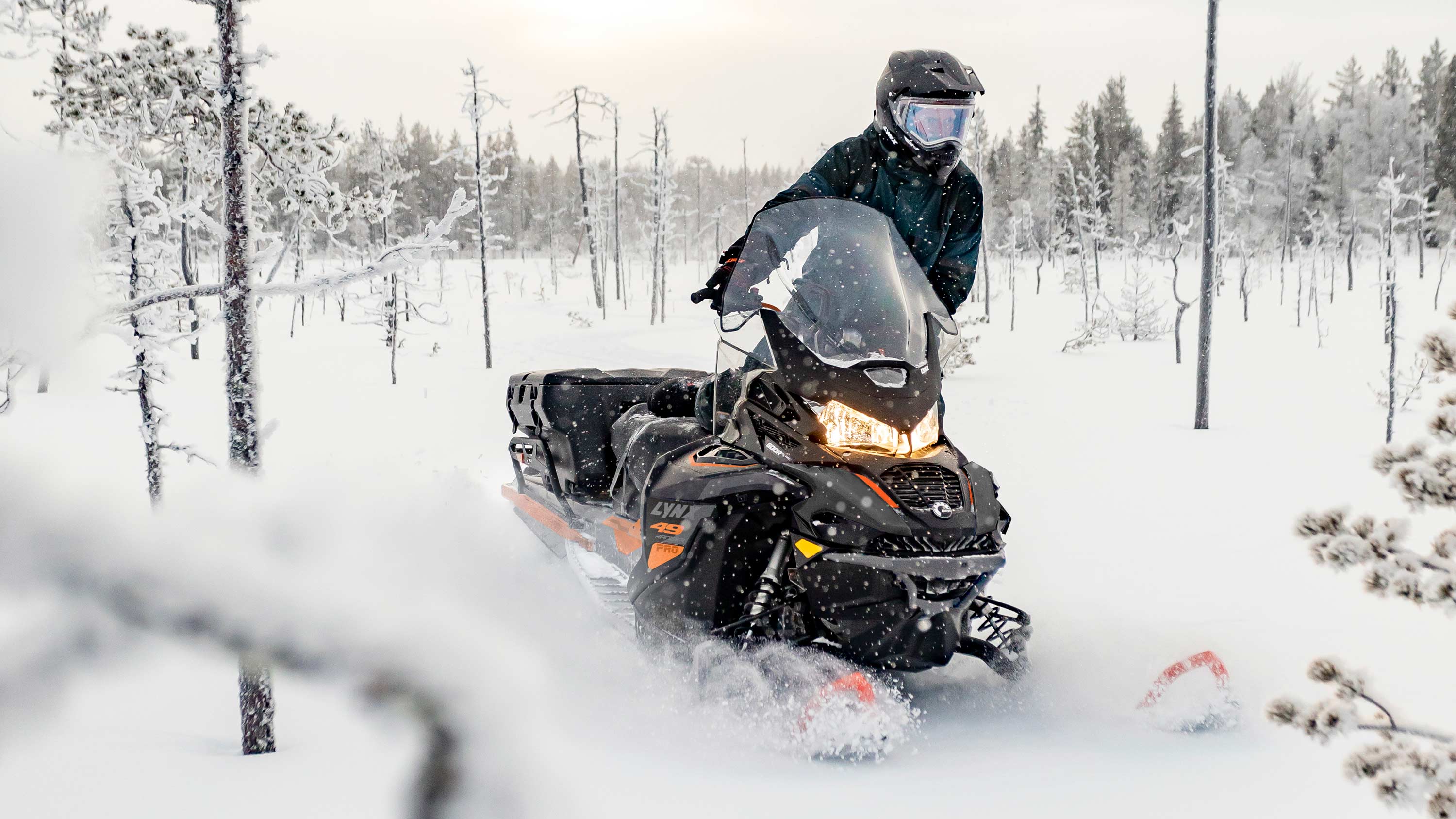 Lynx 49 Ranger Pro snowmobile riding in powder snow