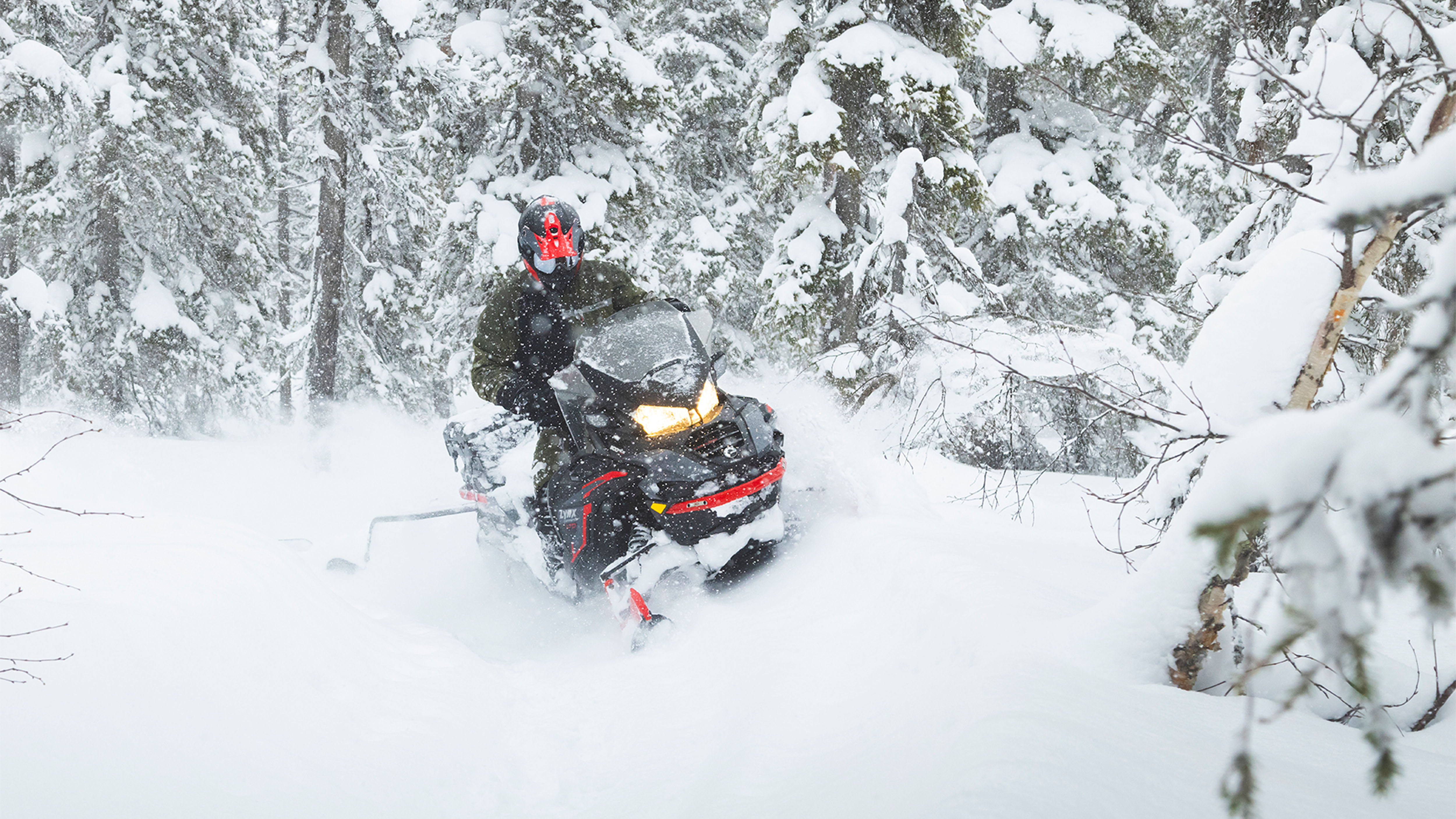 Lynx Commander Limited snowmobile towing a plow in soft snow