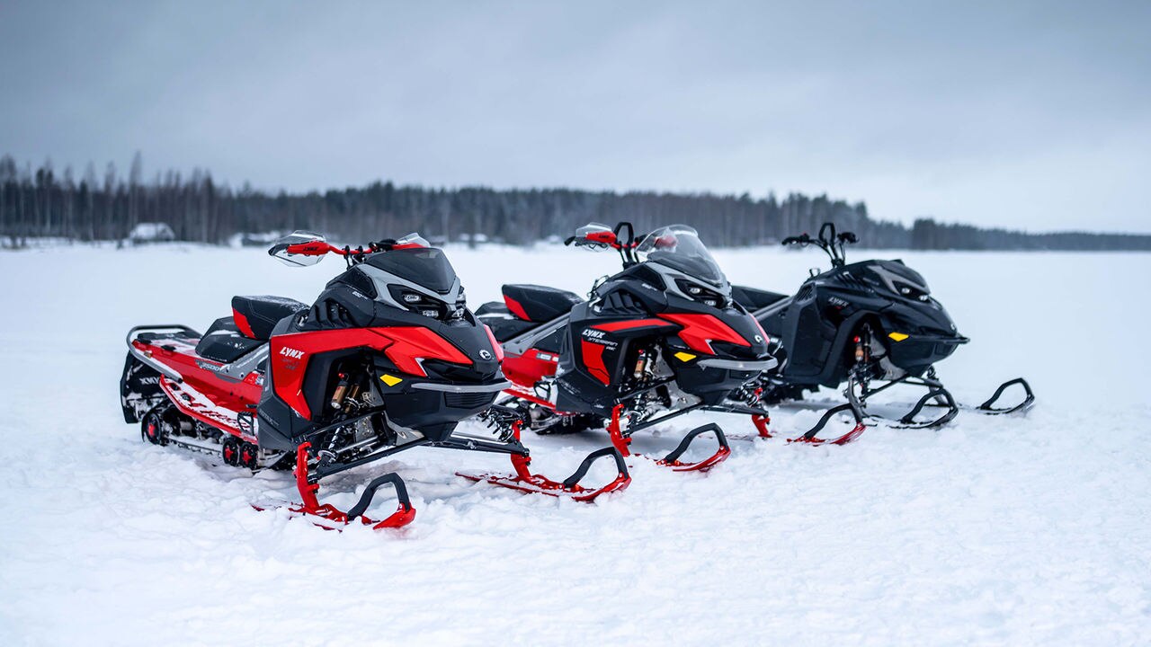 Three Lynx snowmobiles parked on the lake ice