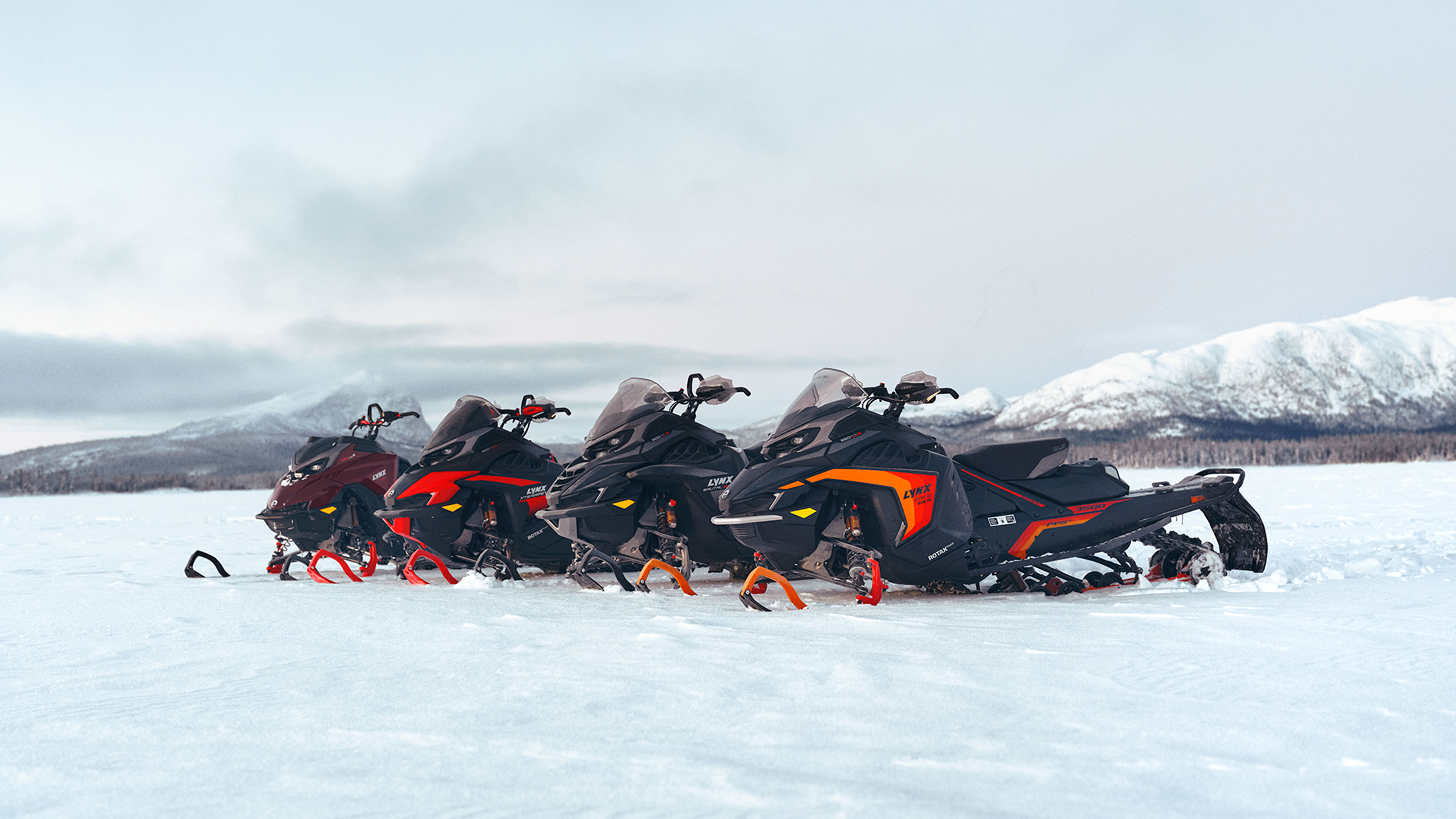 Four 2025 Lynx snowmobiles on lakeice