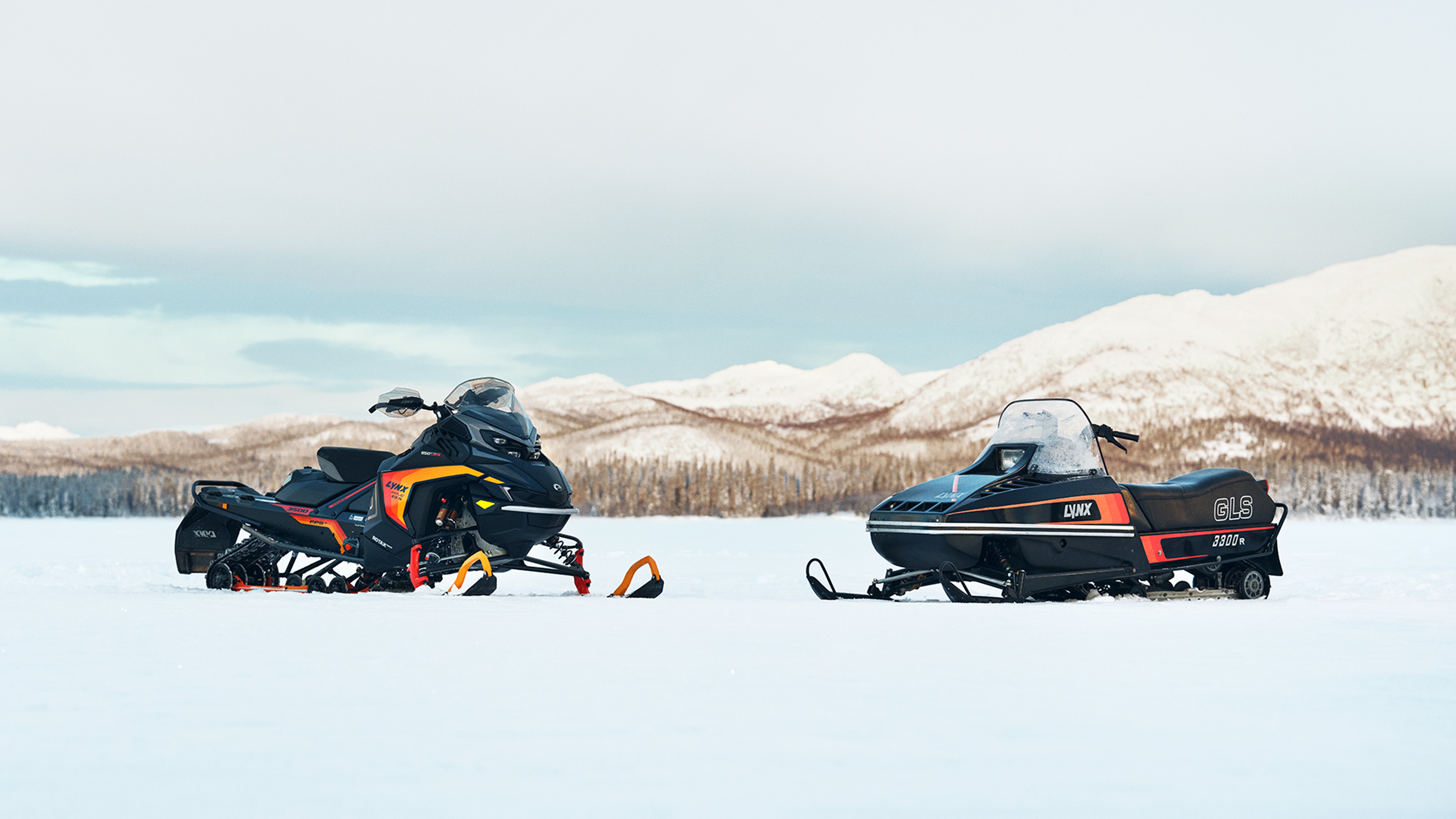 Lynx Rave GLS 2025 and retro Lynx GLS 3300 snowmobile on the lake ice