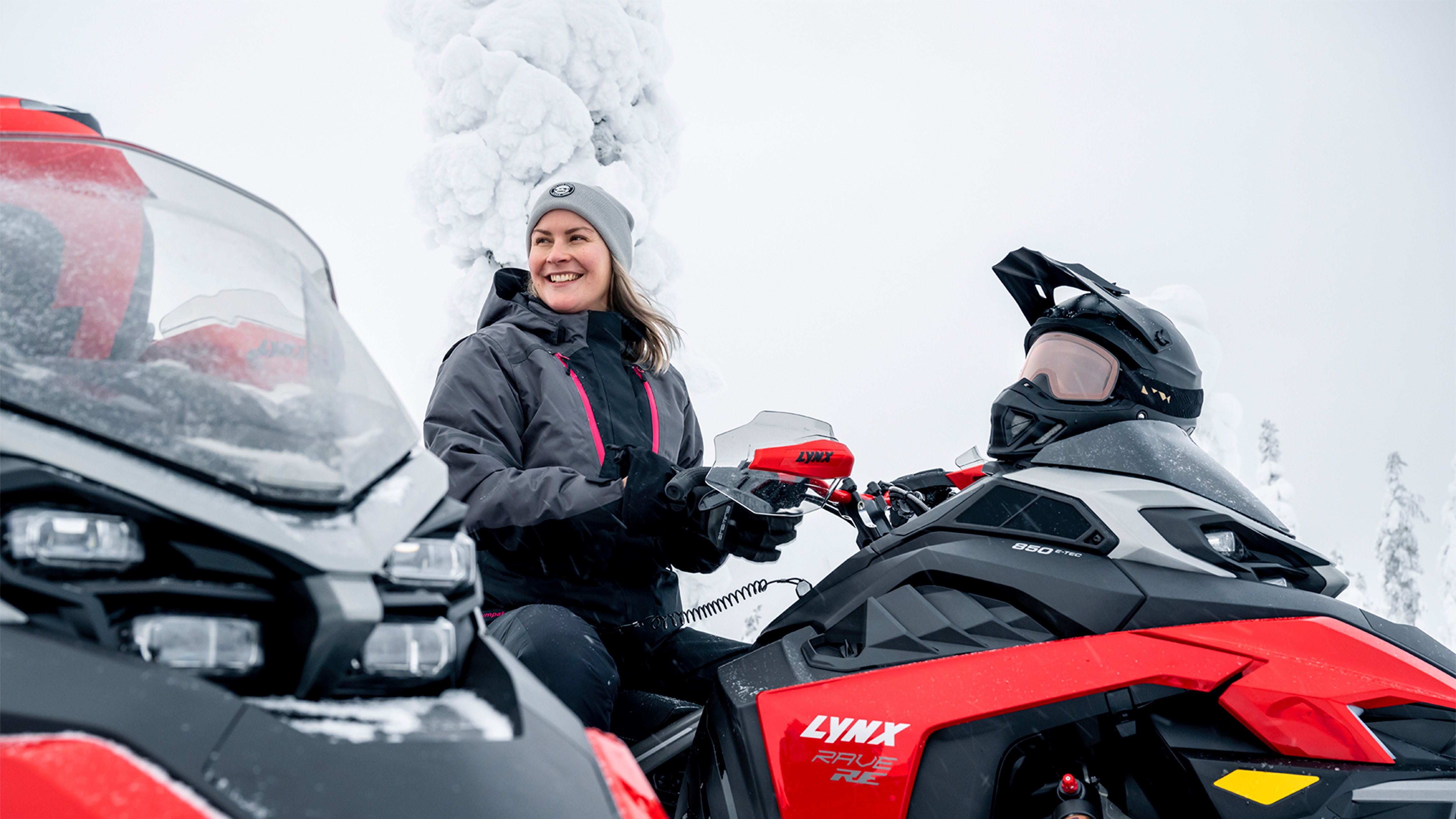  Woman laughing on Lynx Rave RE snowmobile