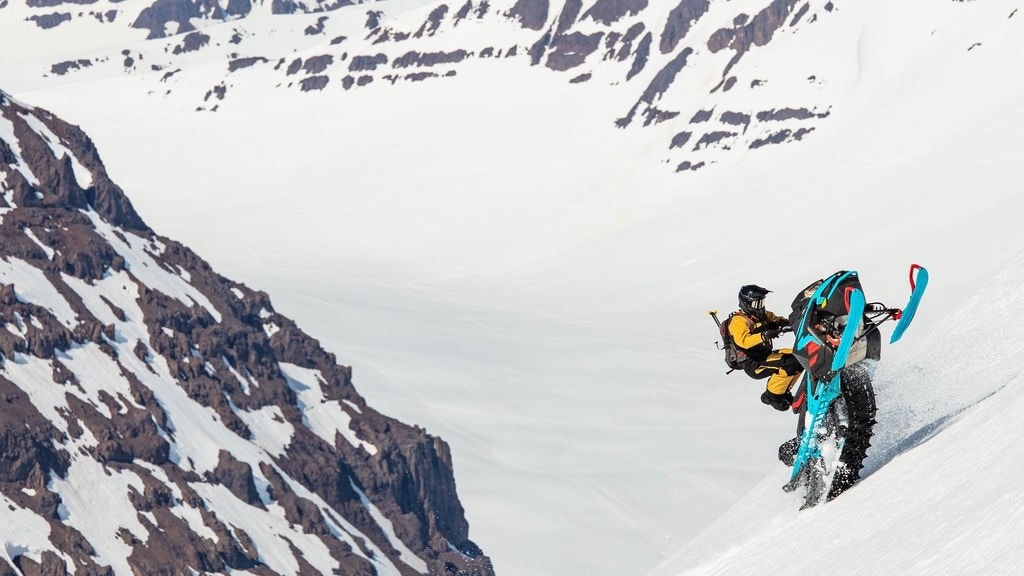 Man riding a Lynx snowmobile on a mountain in Iceland