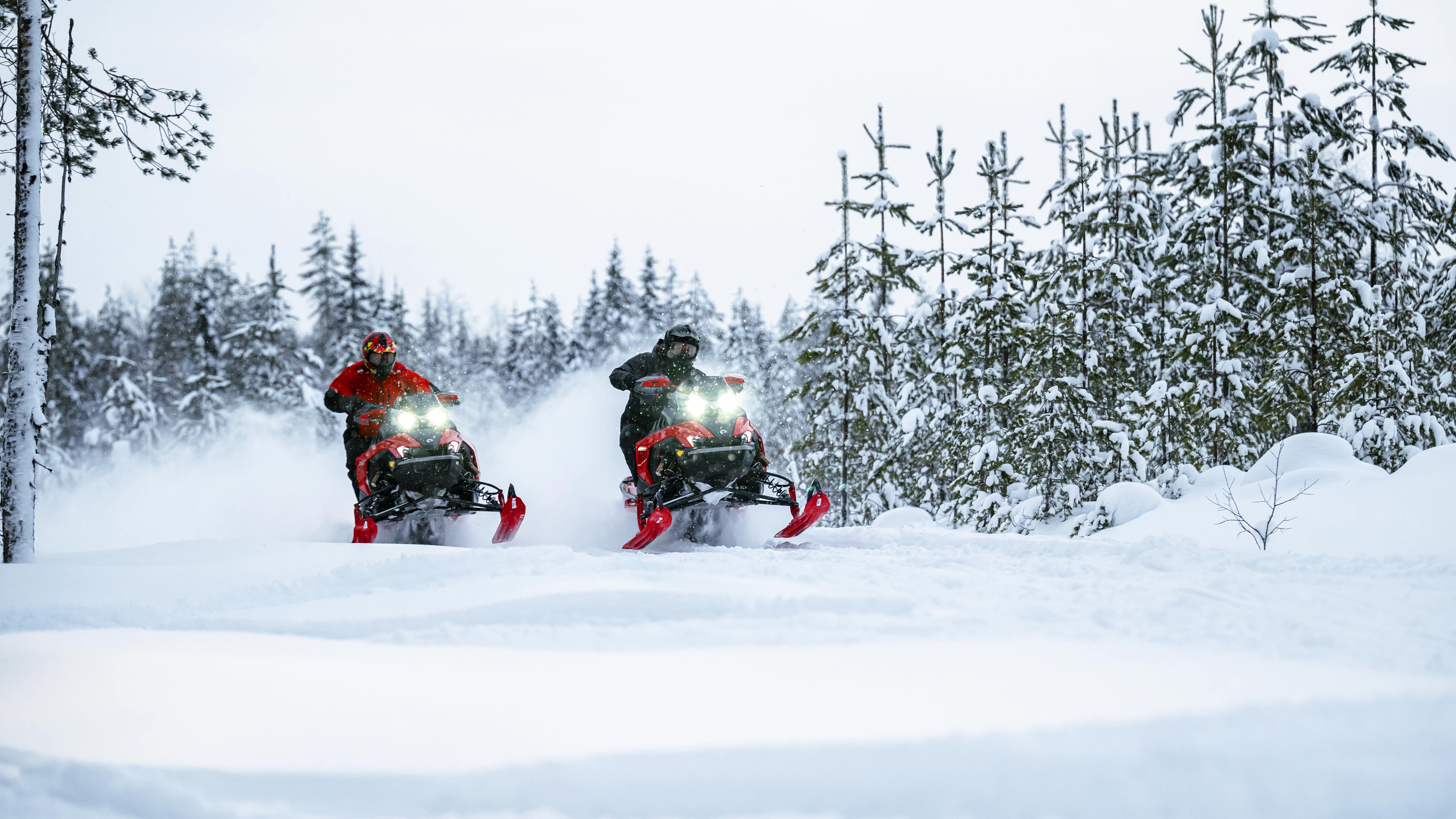 Two snowmobilers riding the new Lynx sleds