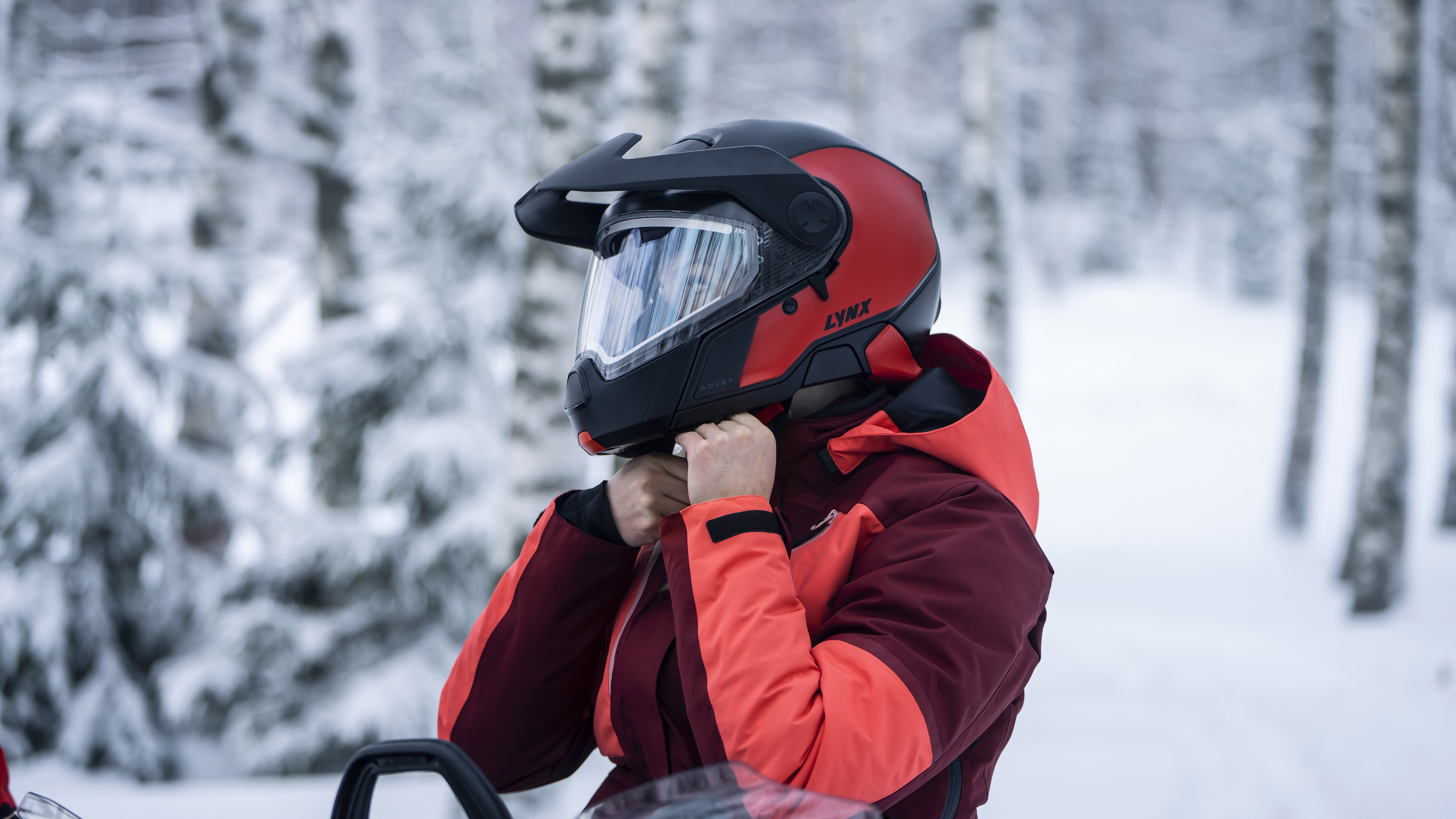 Woman putting on the new Lynx Advex Helmet