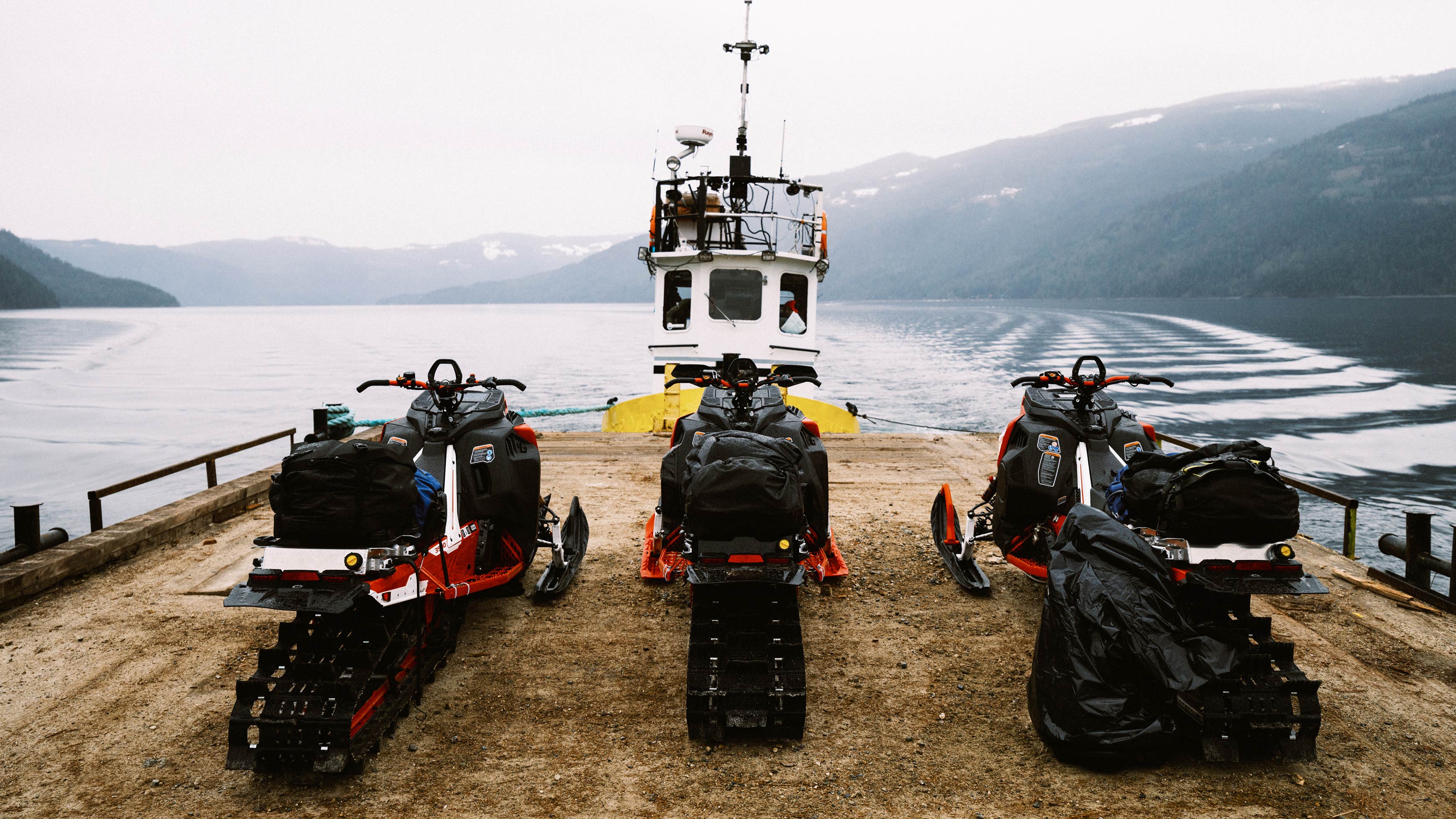 3 Lynx snowmobiles on a ferry