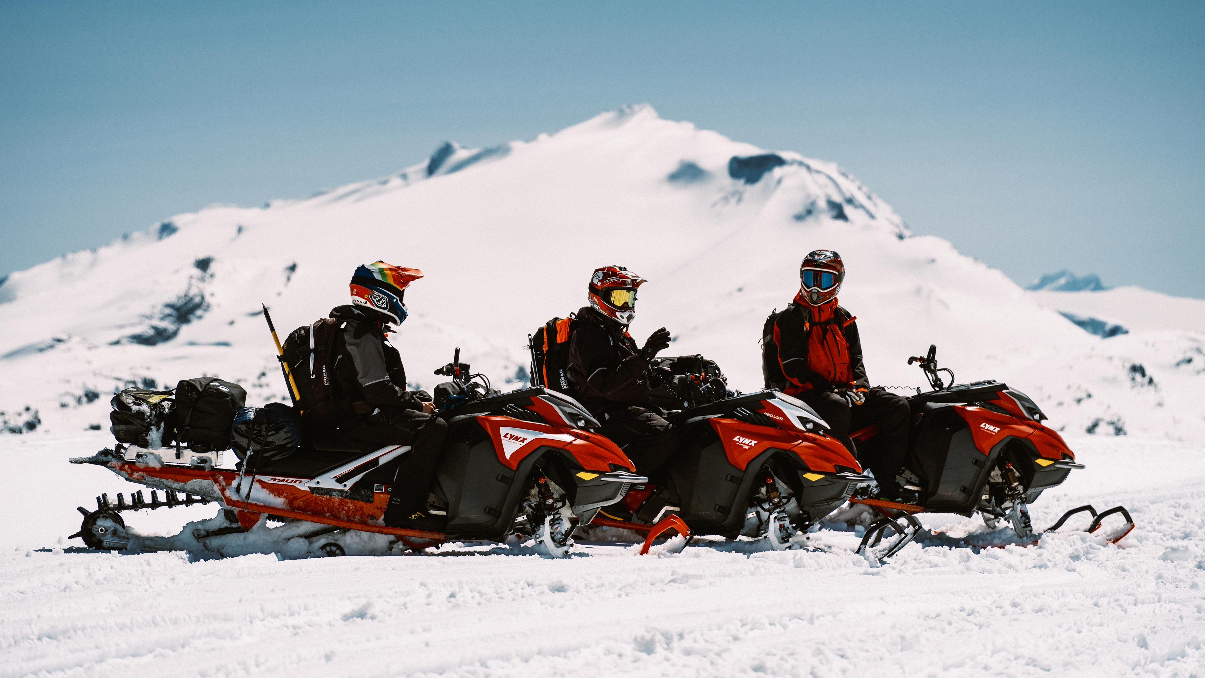 3 Lynx riders sitting on their sleds