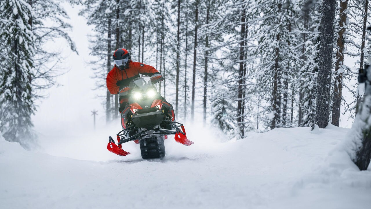 Man snowmobiling with the 2024 Lynx Xterrain RE