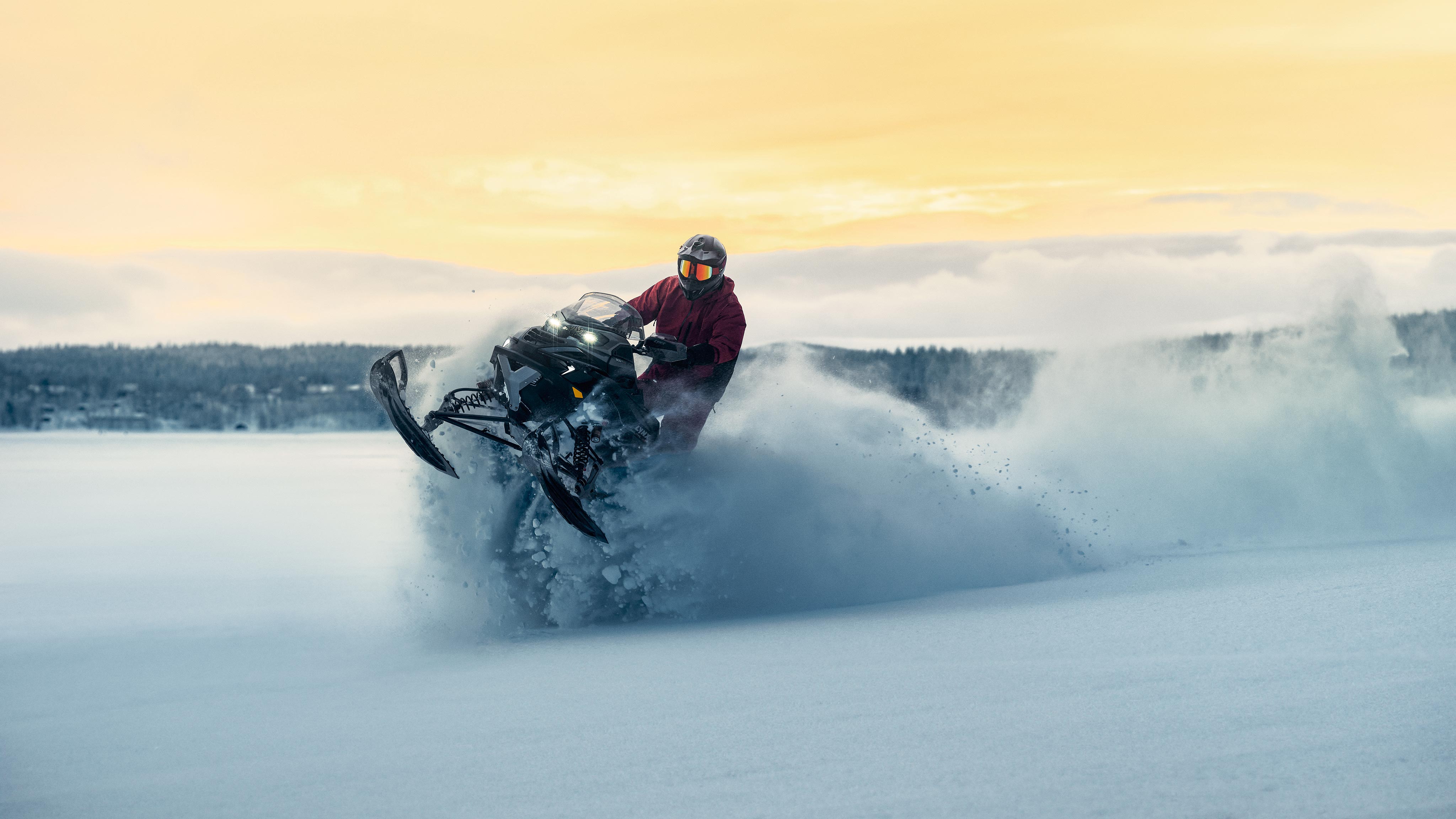  Lynx Brutal RE 2025 snowobile parked on lake ice at sunrise