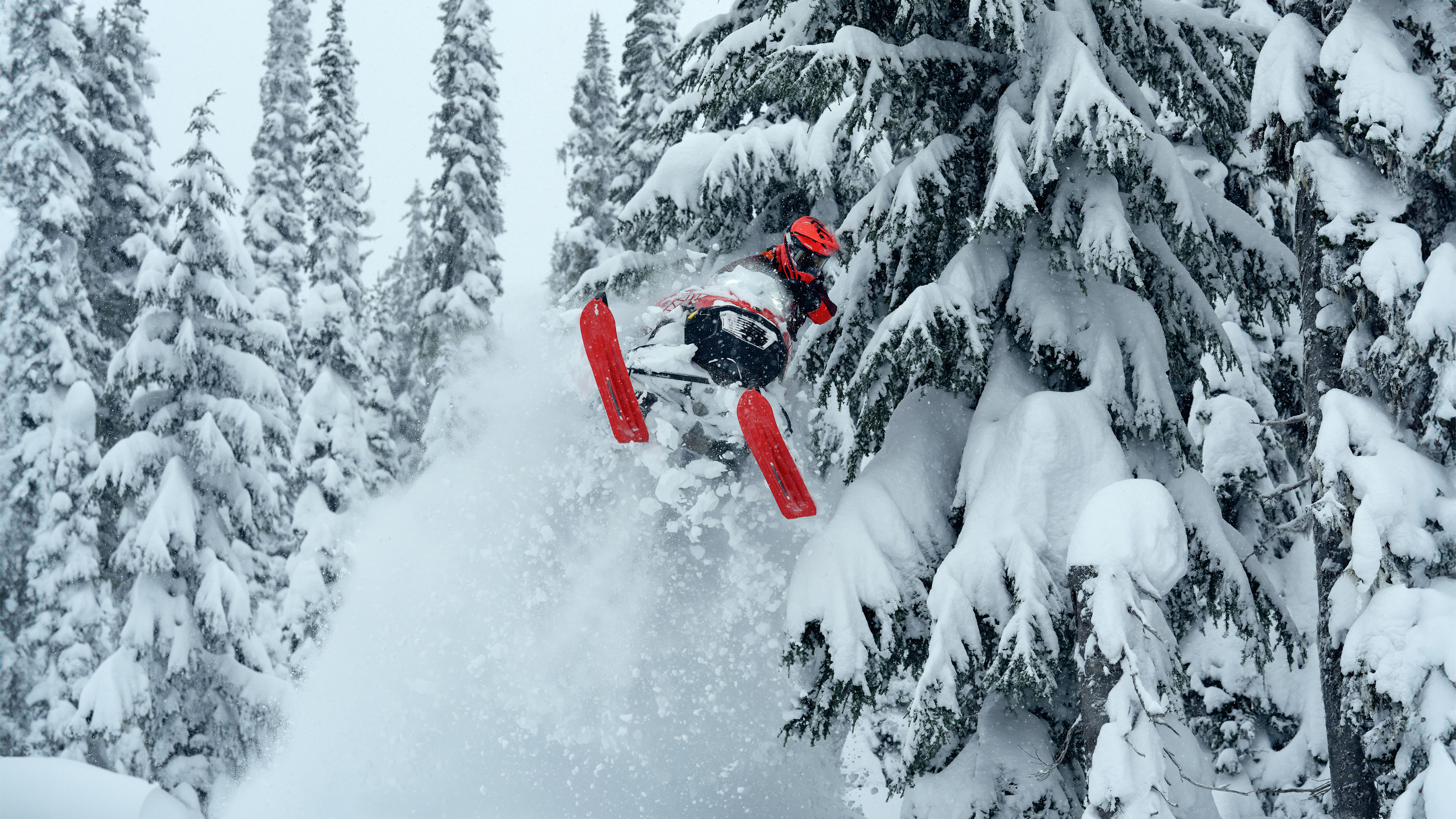 Rider jumping out of deep snow on a 2026 Lynx Shredder snowmobile
