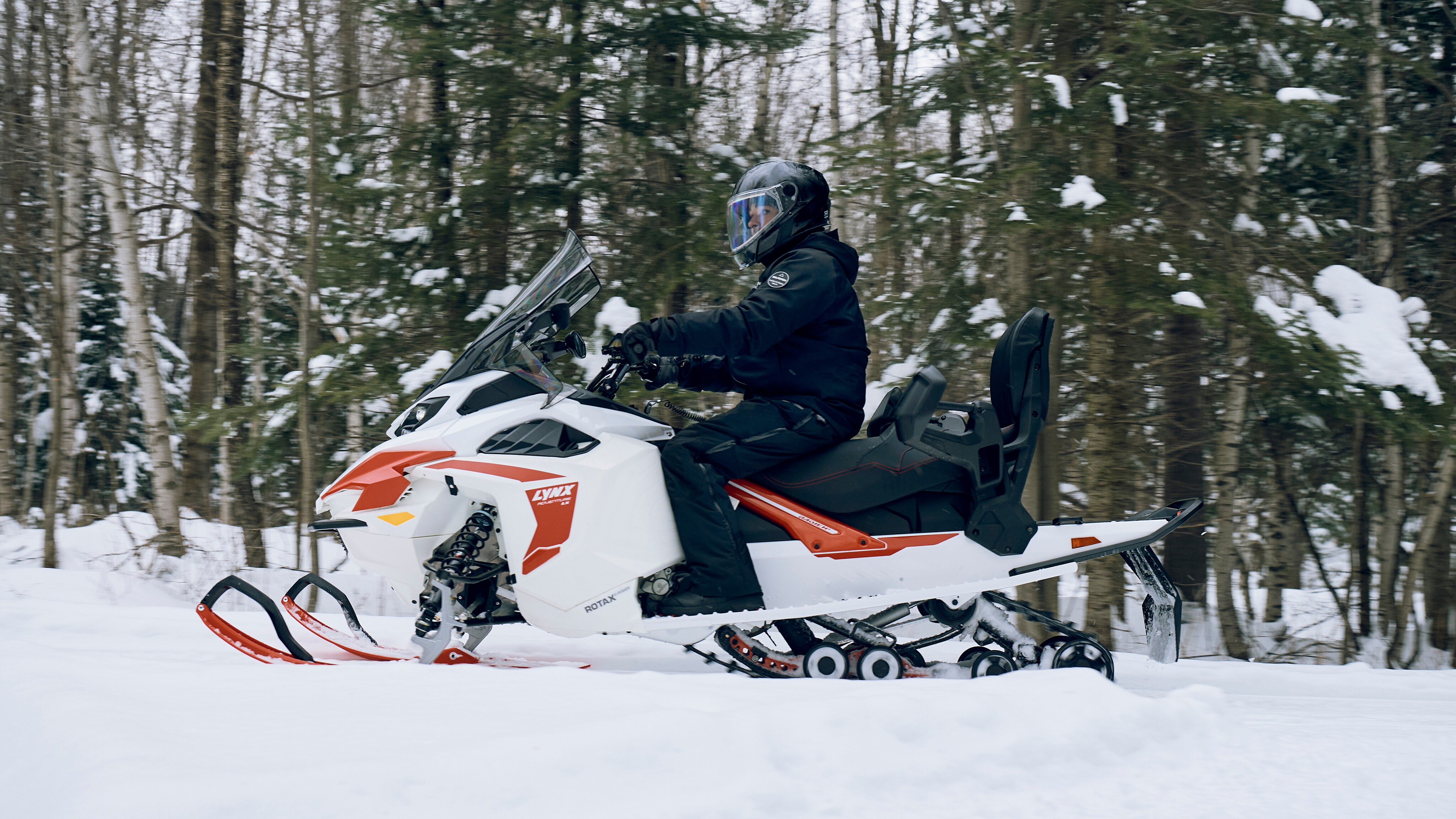 Man snowmobiling in trail with the 2024 Adventure Electric