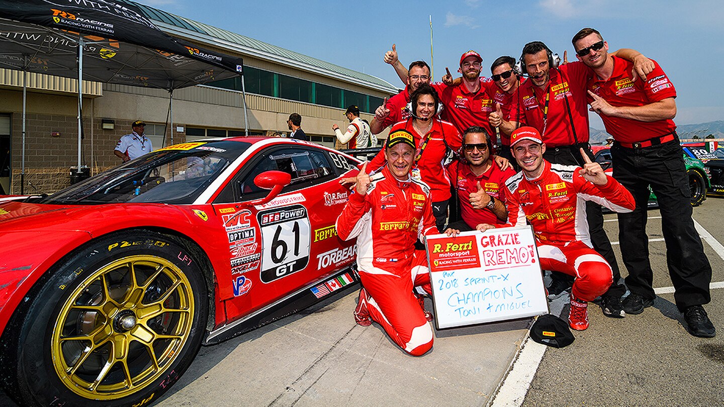 Race team on a pit with a race car.