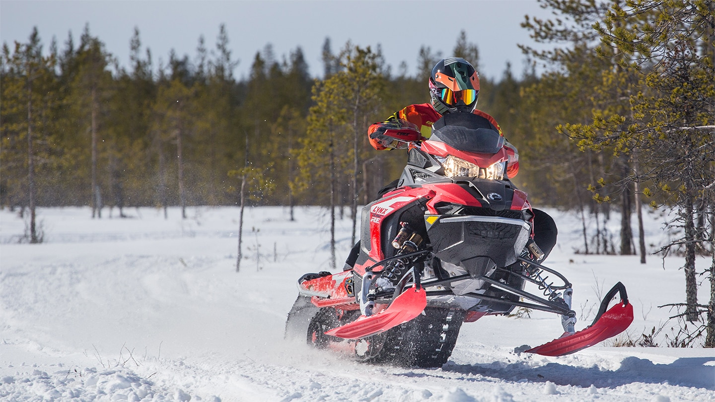 A race driver Toni Vilander rides on trail with Lynx Rave RE snowmobile in Lapland, Finland.