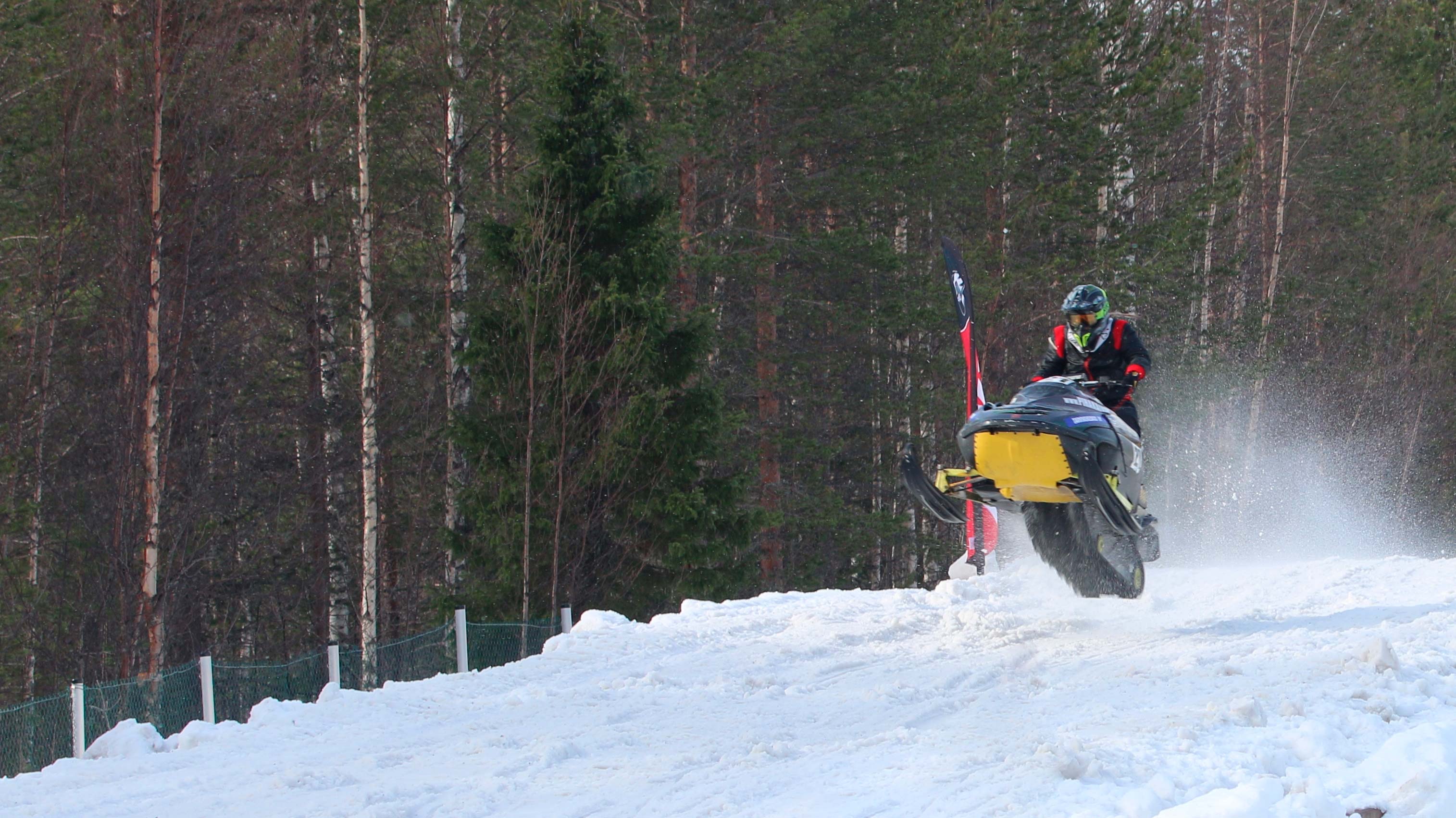 Retro Lynx snowmobile jumps on a race track