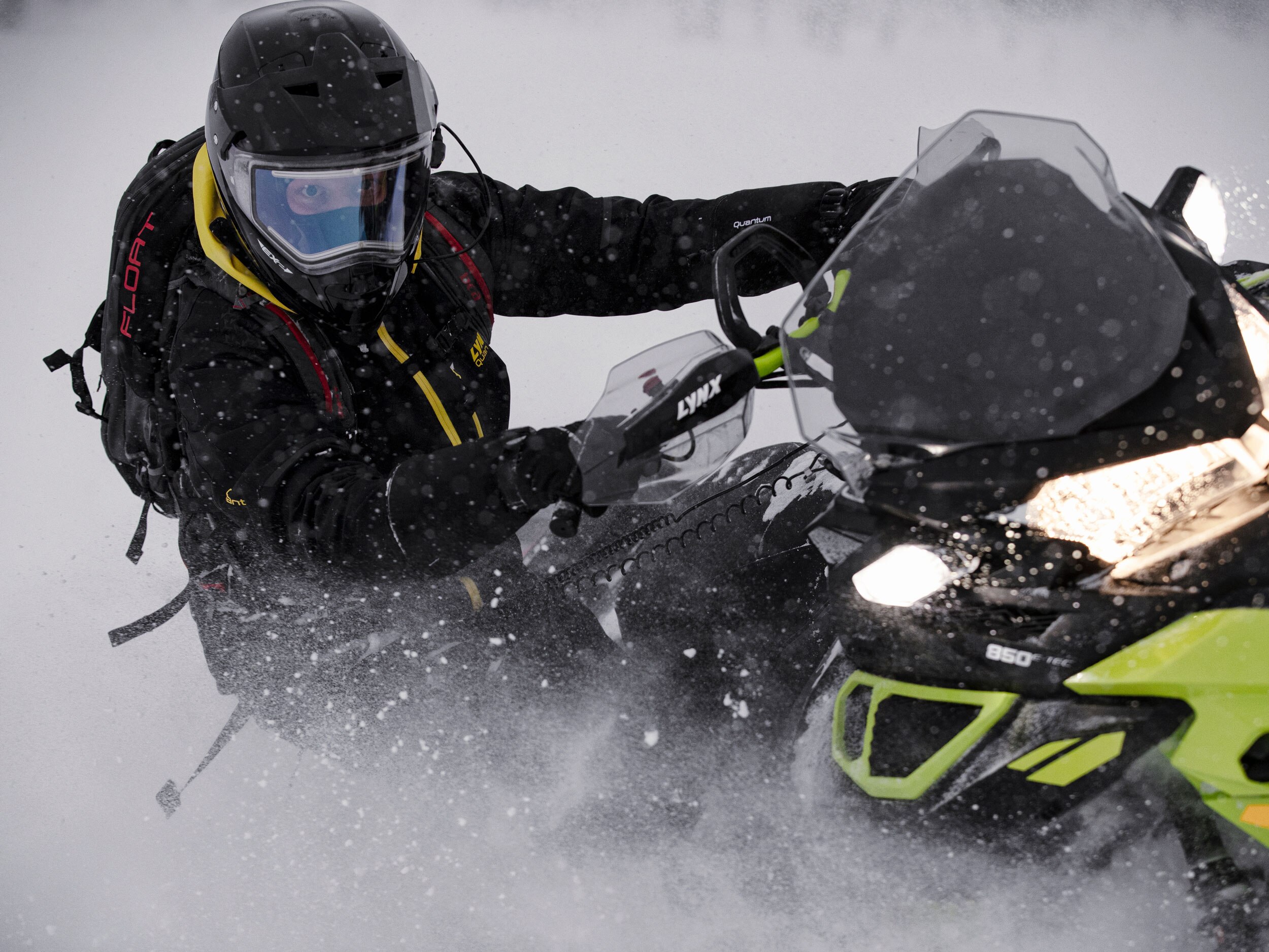 Lynx rider wearing techno wear on deep snow riding