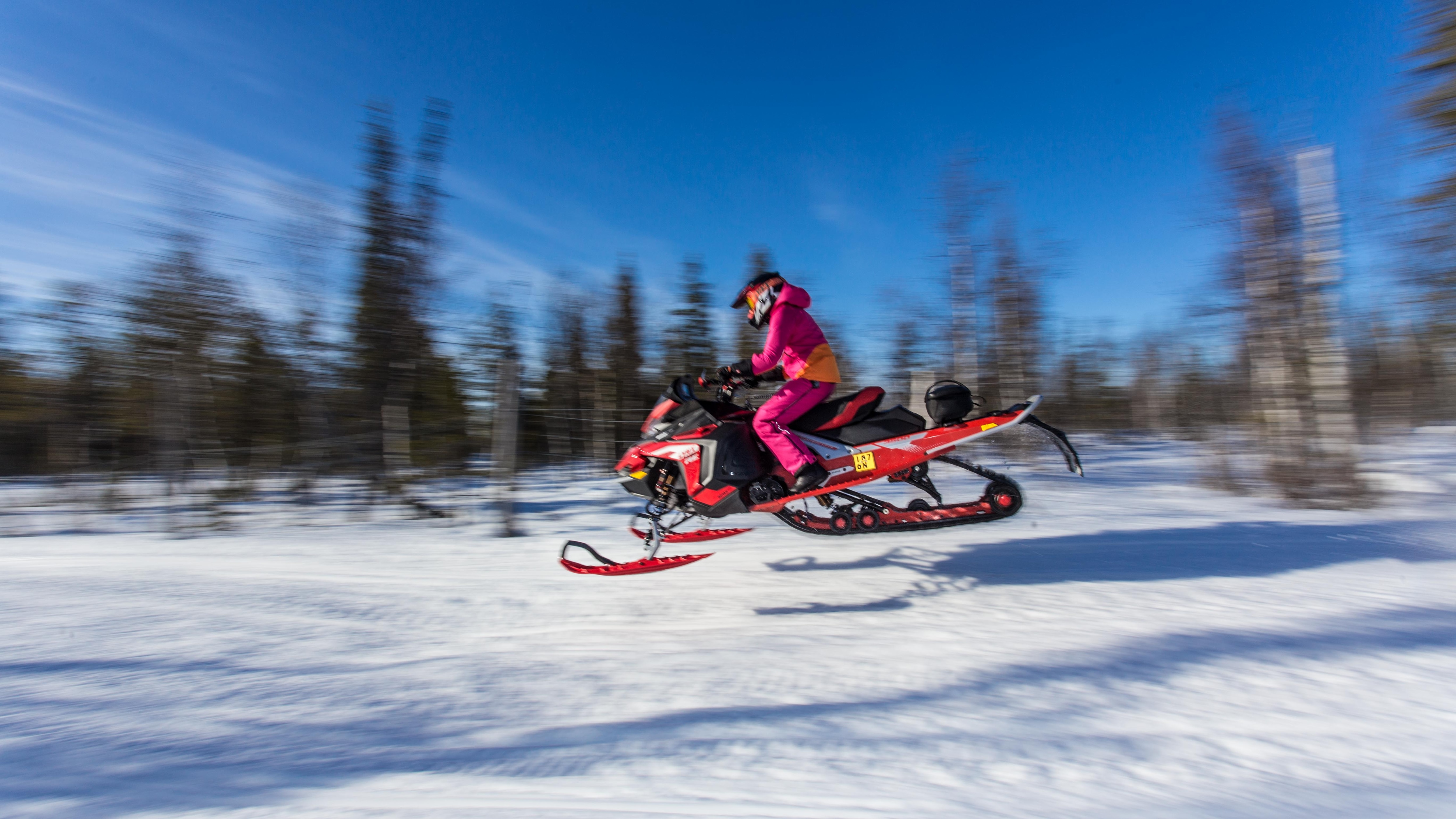 Finnish formula driver Emma Kimiläinen rides with Lynx Rave RE 850 2022 snowmobile on trail