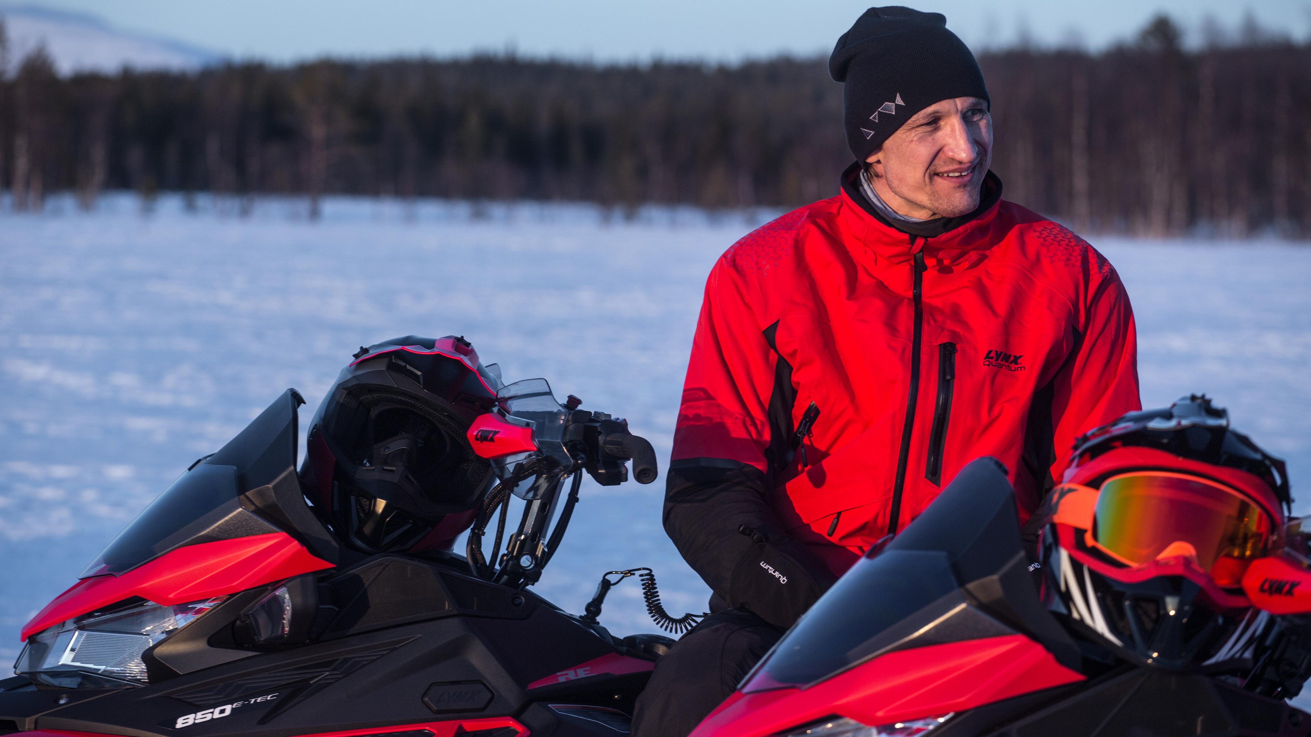 Football player Sami Hyypiä chatting on Lynx snowmobile