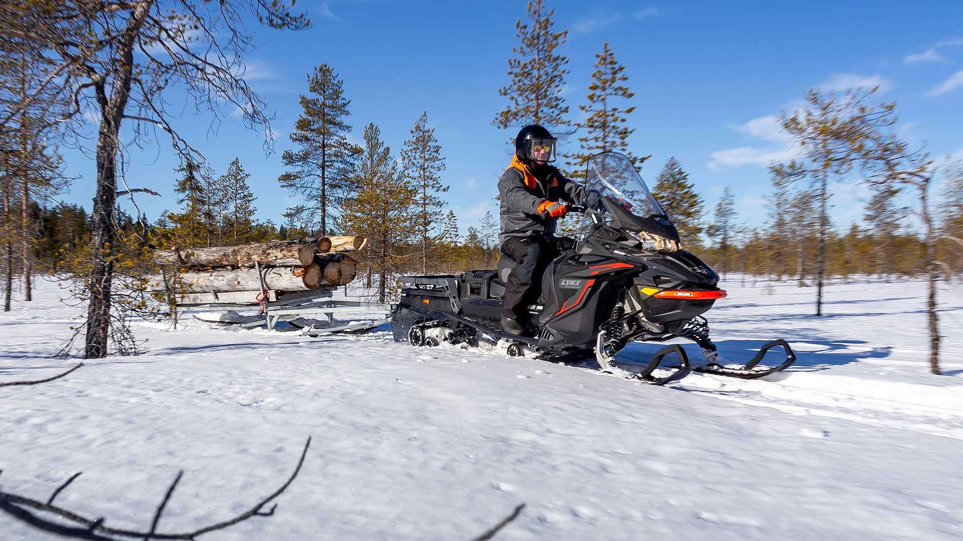 Lynx Commander snowmobile Hauling logs