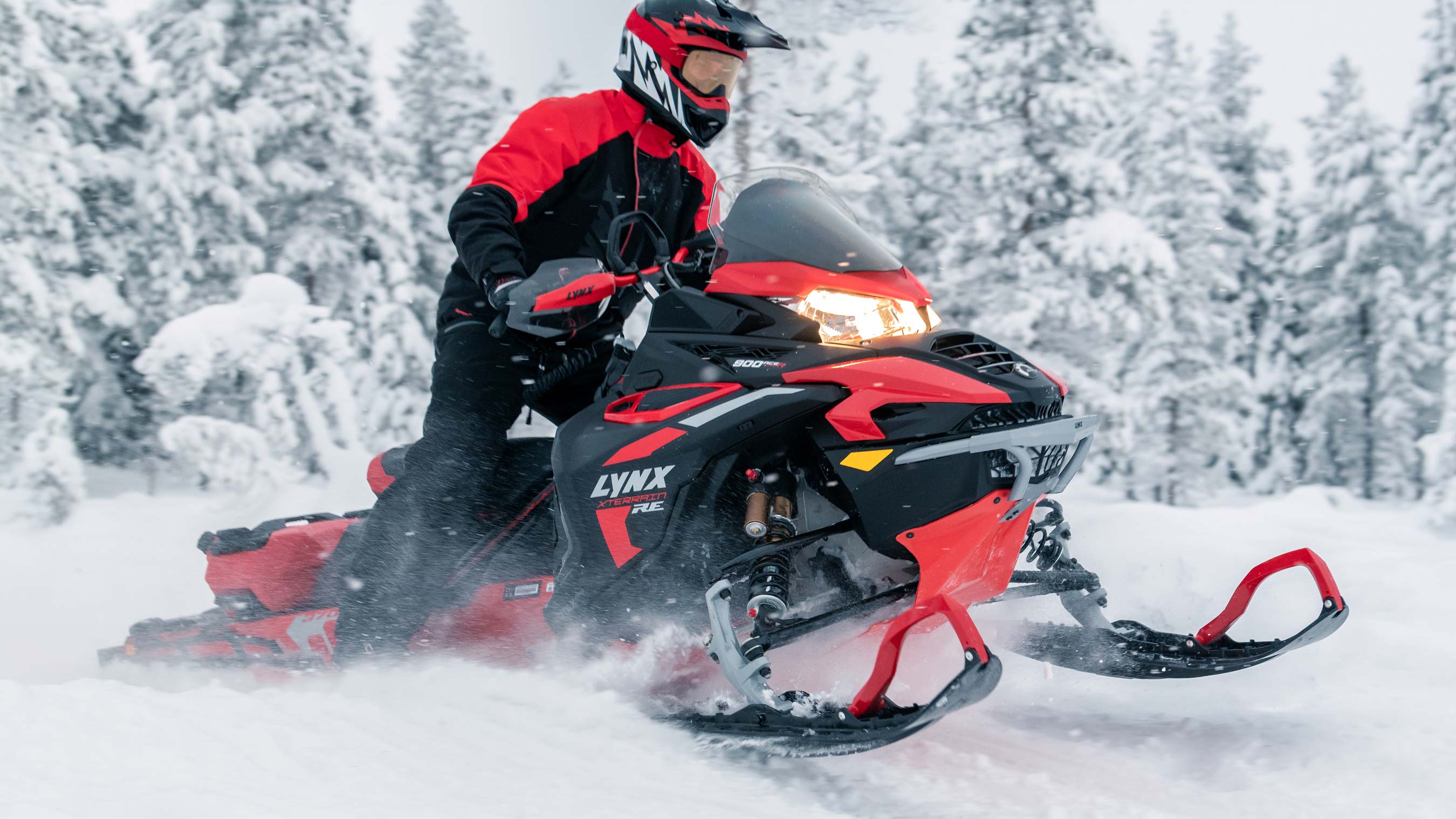 Lynx Xterrain RE snowmobile riding in snowy forest