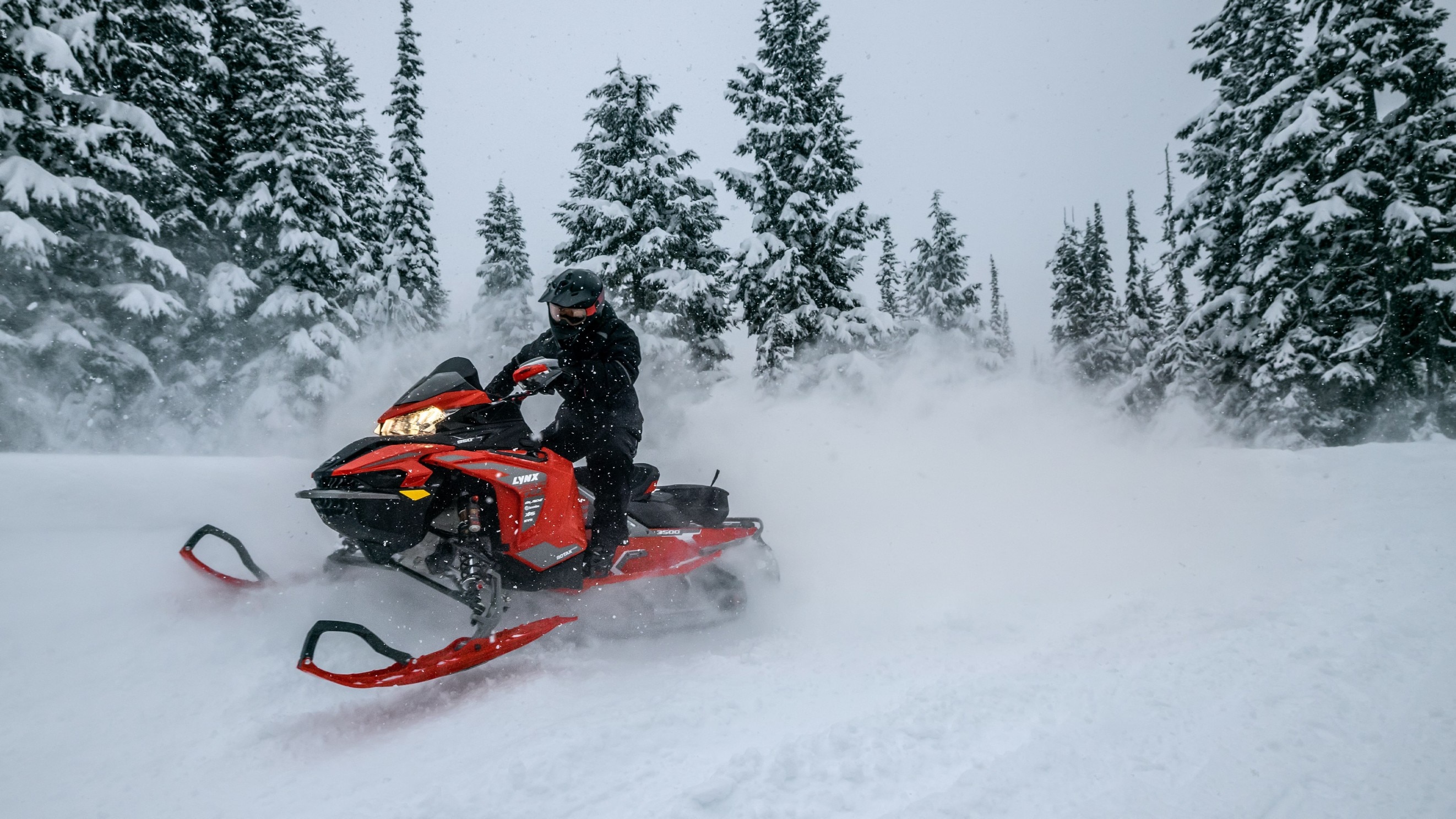 Man riding the his Lynx Rave on a snowmobile trail