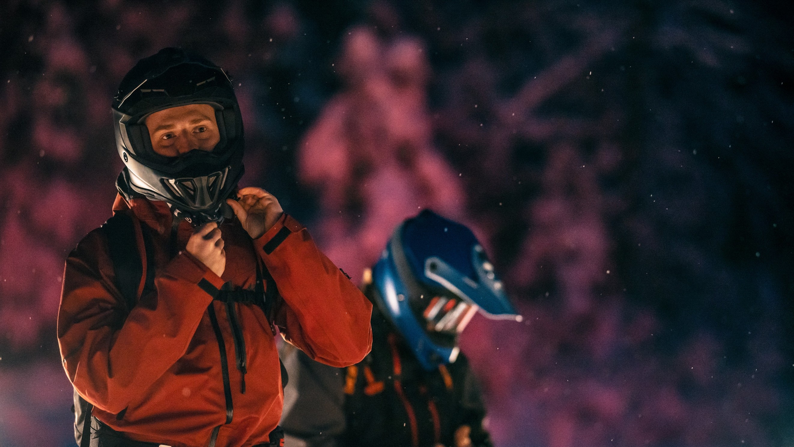 Man wearing a snowmobile helmet before a snowmobile ride