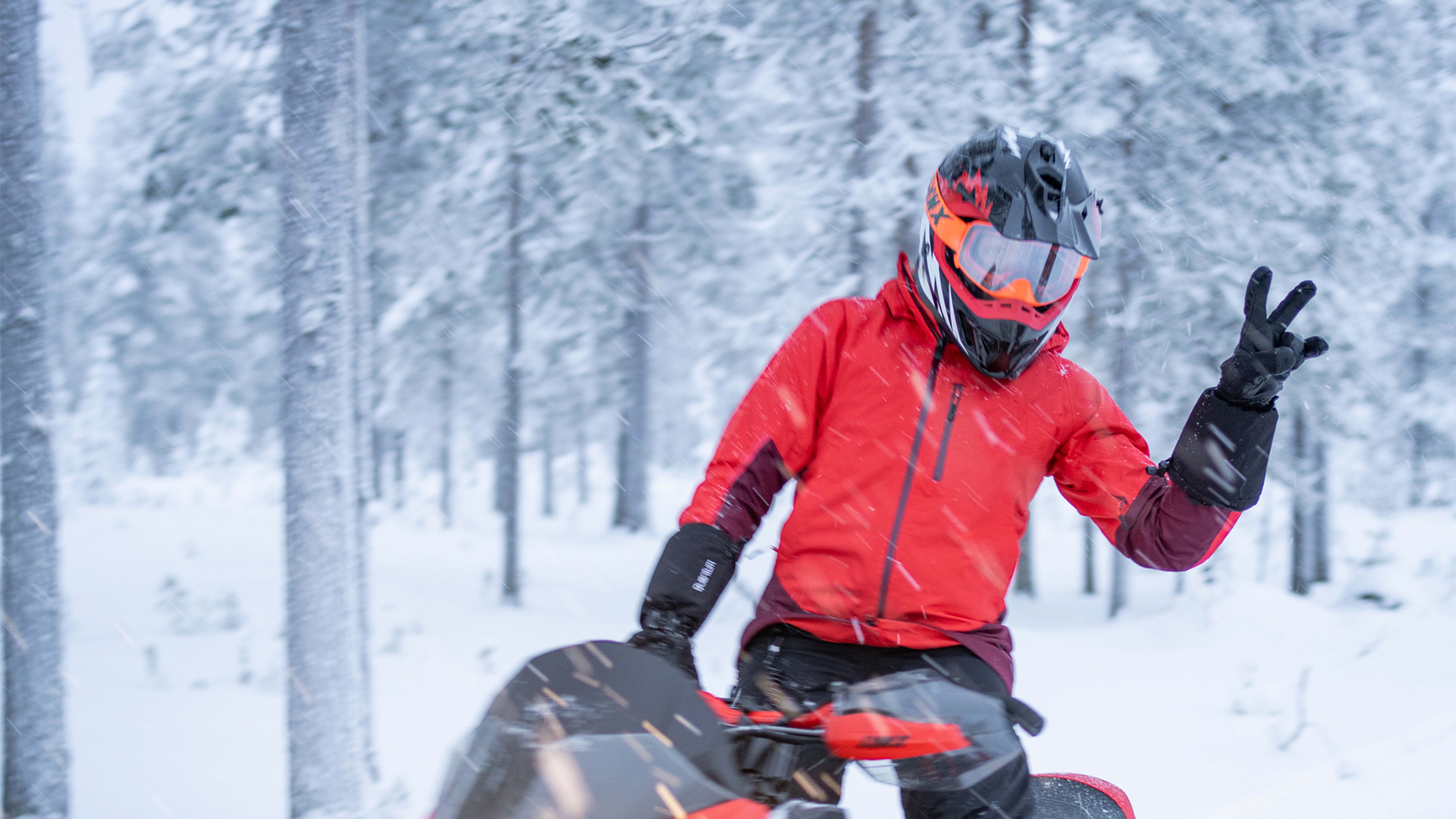 Woman posing on a snowmobile