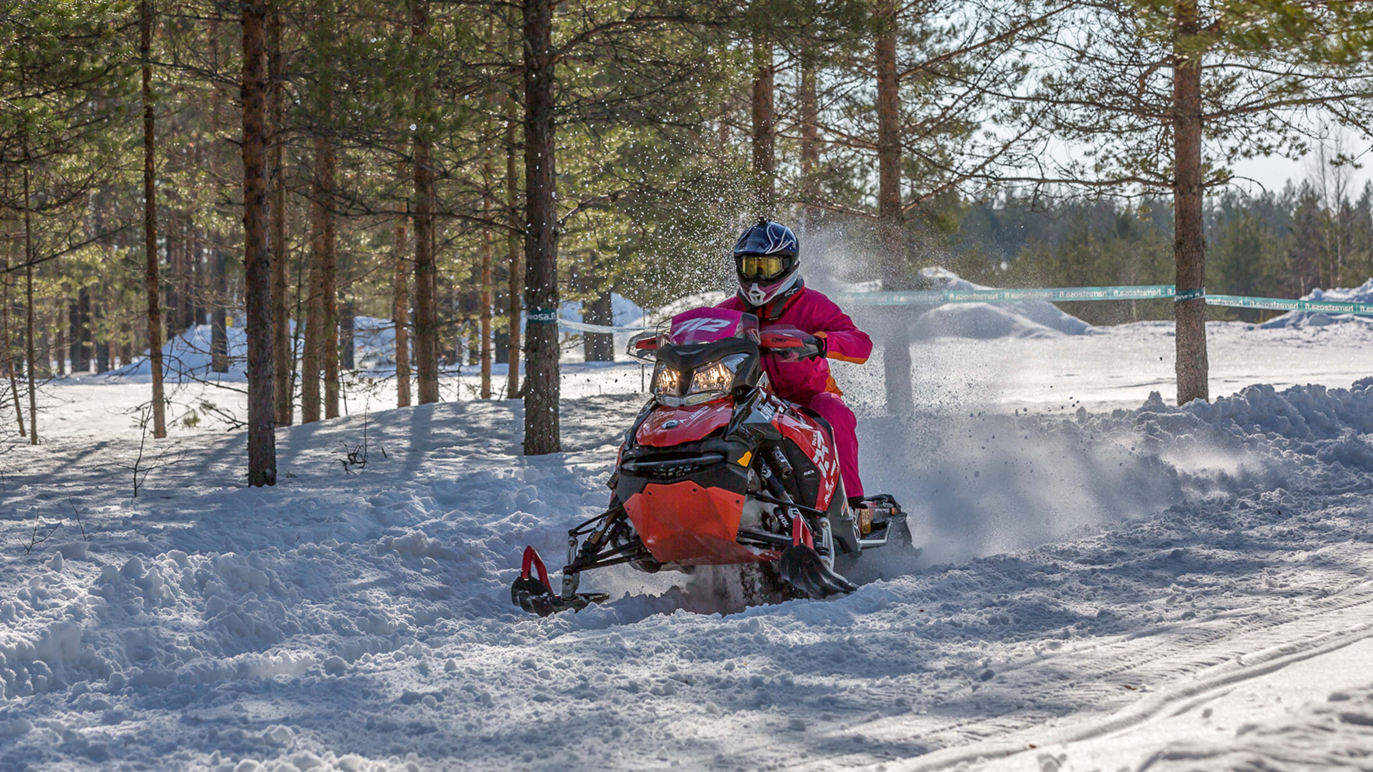A woman rides a snowmobile in endurance race