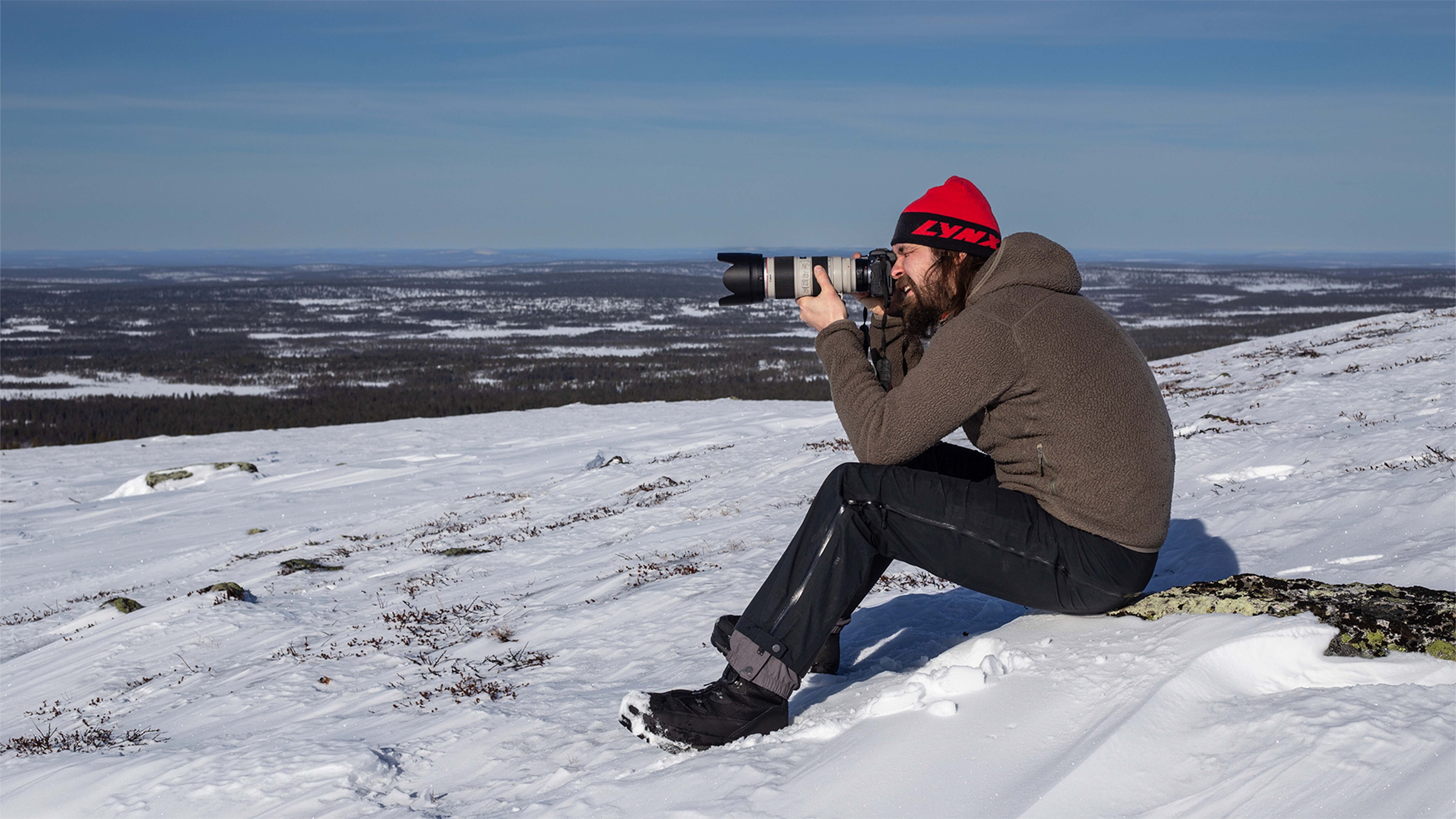 A man is taking photos in the top of the fell