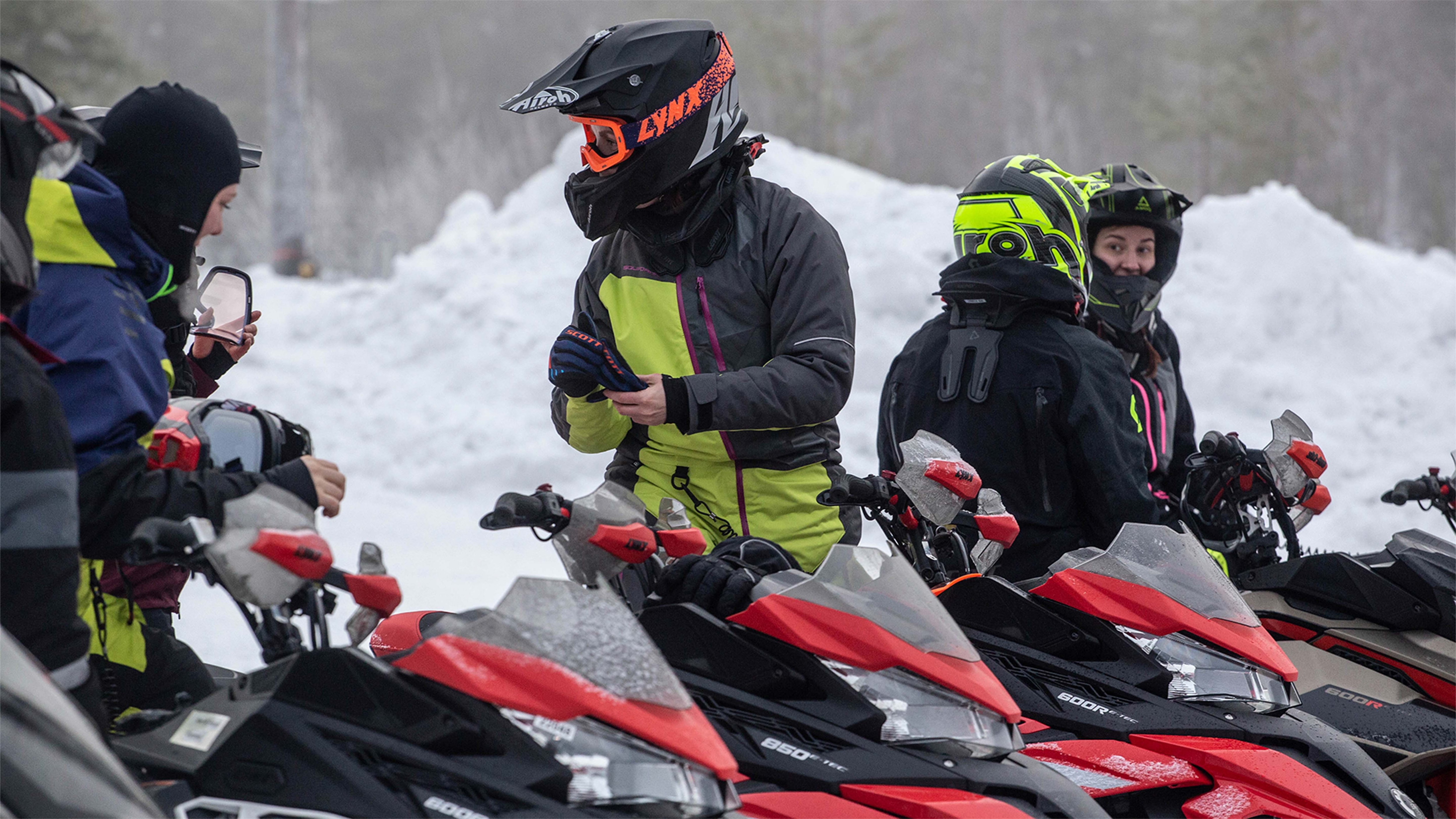 Snowmobile riders having a chat on a break