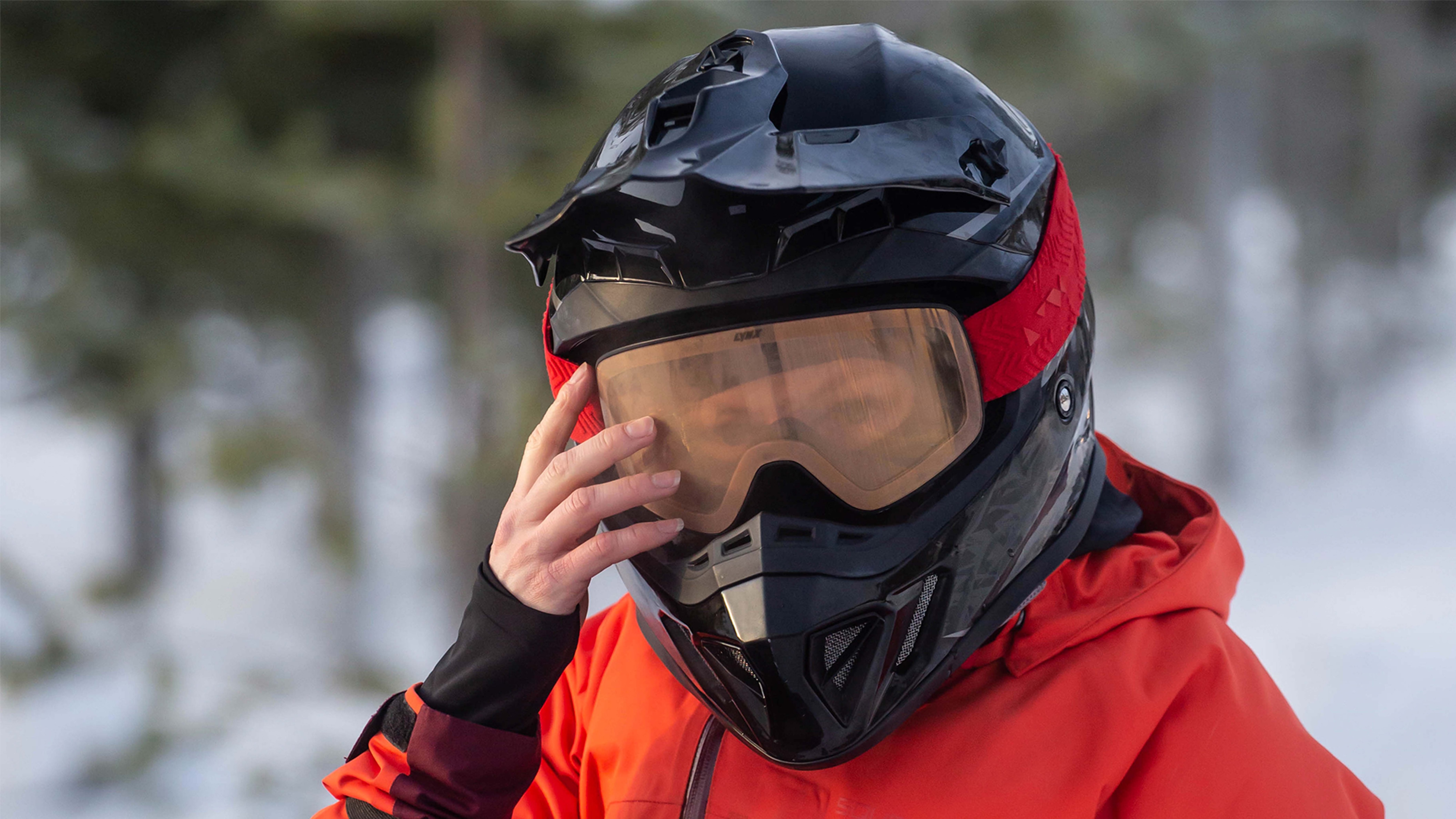 Snowmobile rider wearing goggles and helmet