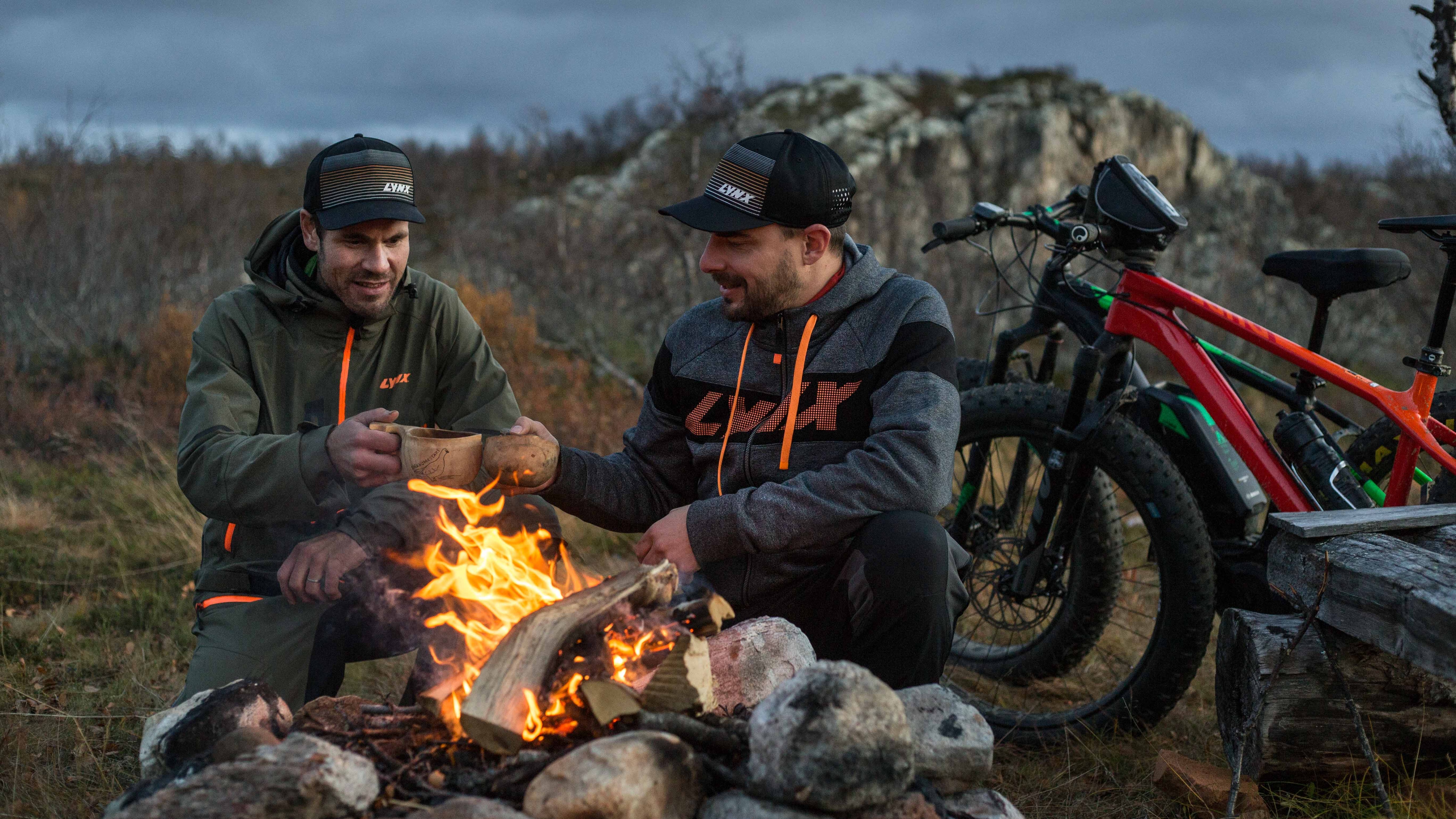 Lynx riders having a break around fire place