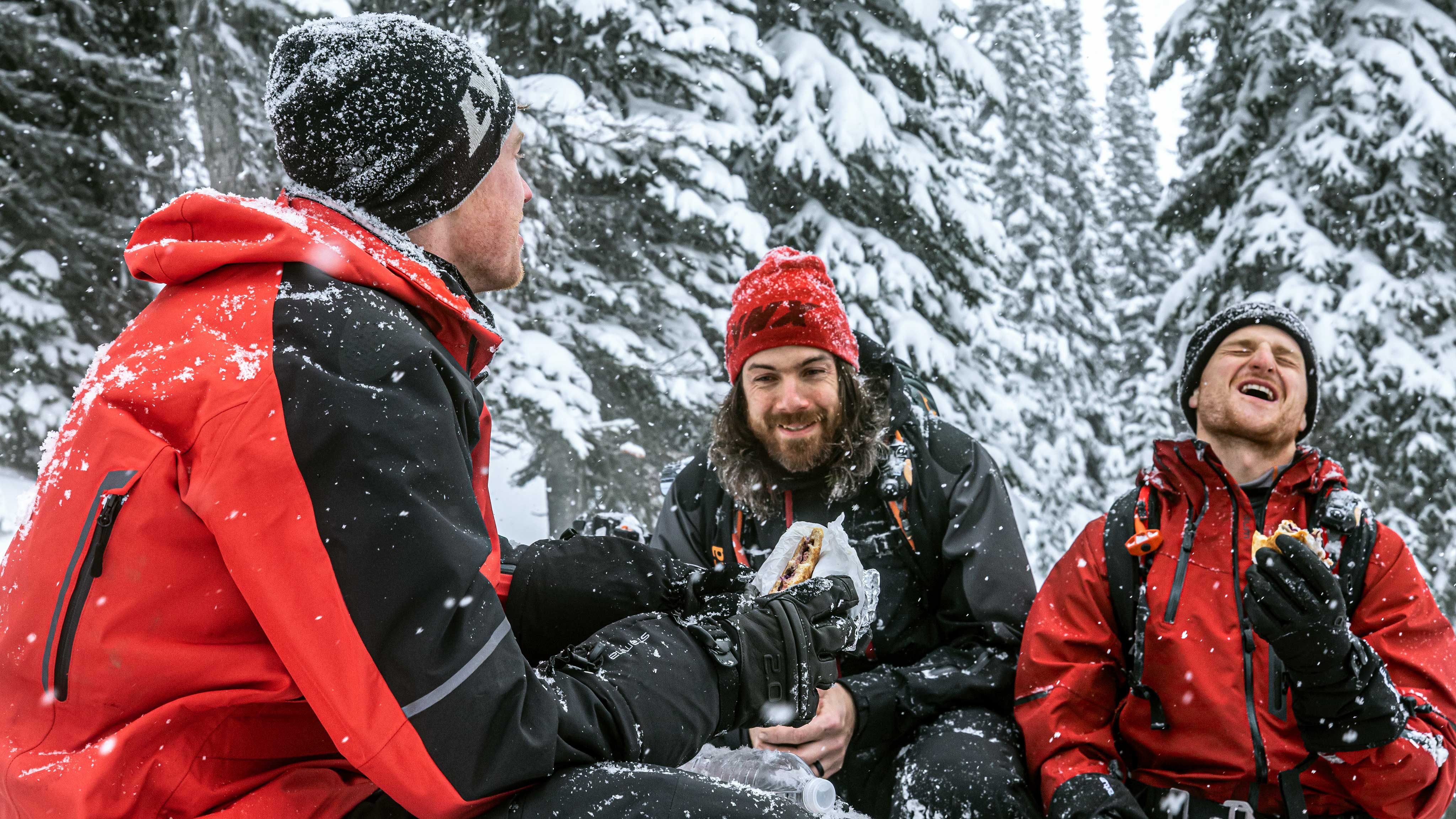 Friends catching up and talking about their wild Lynx snowmobile riding experiences