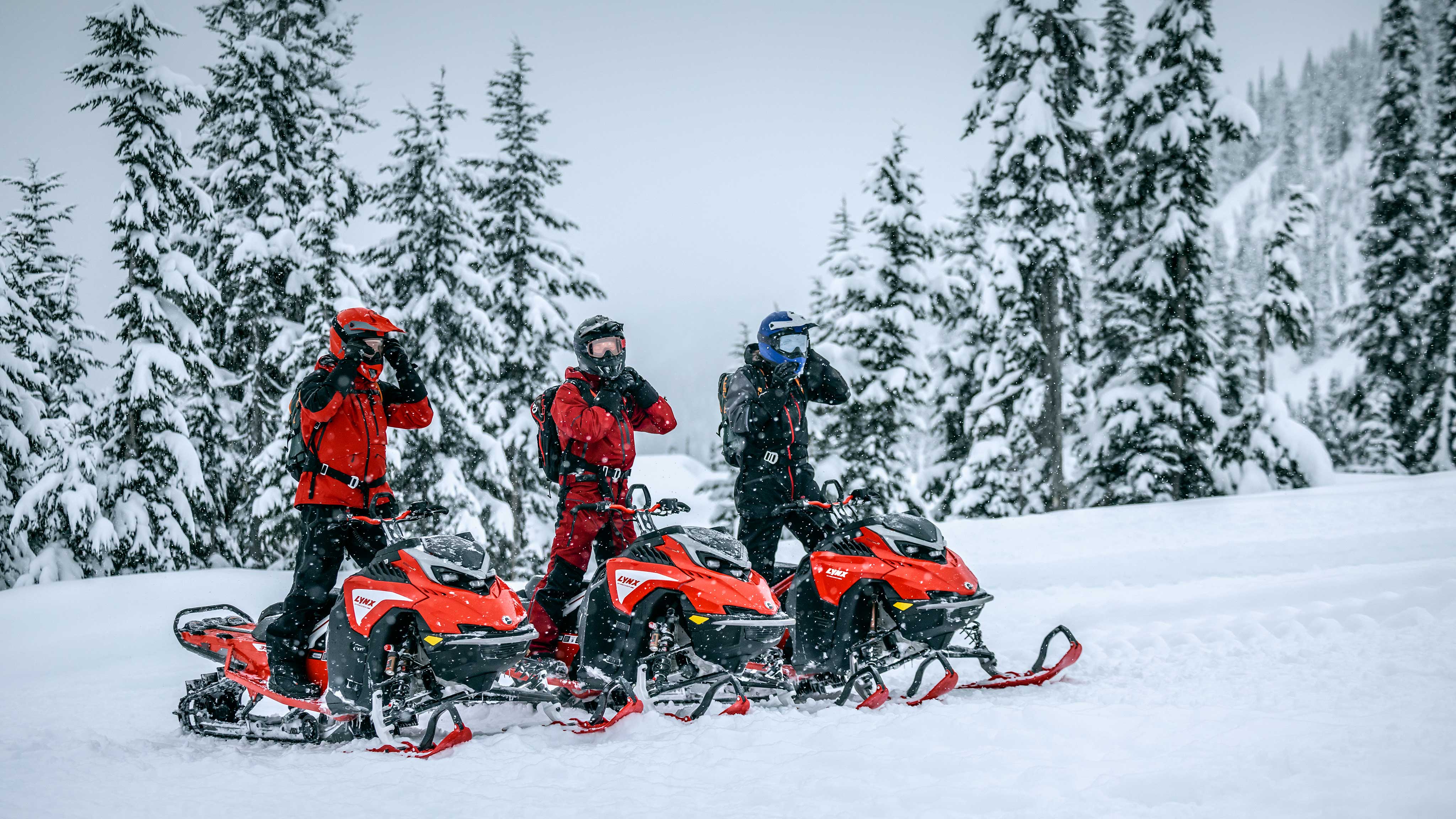3 riders with their Lynx snowmobiles