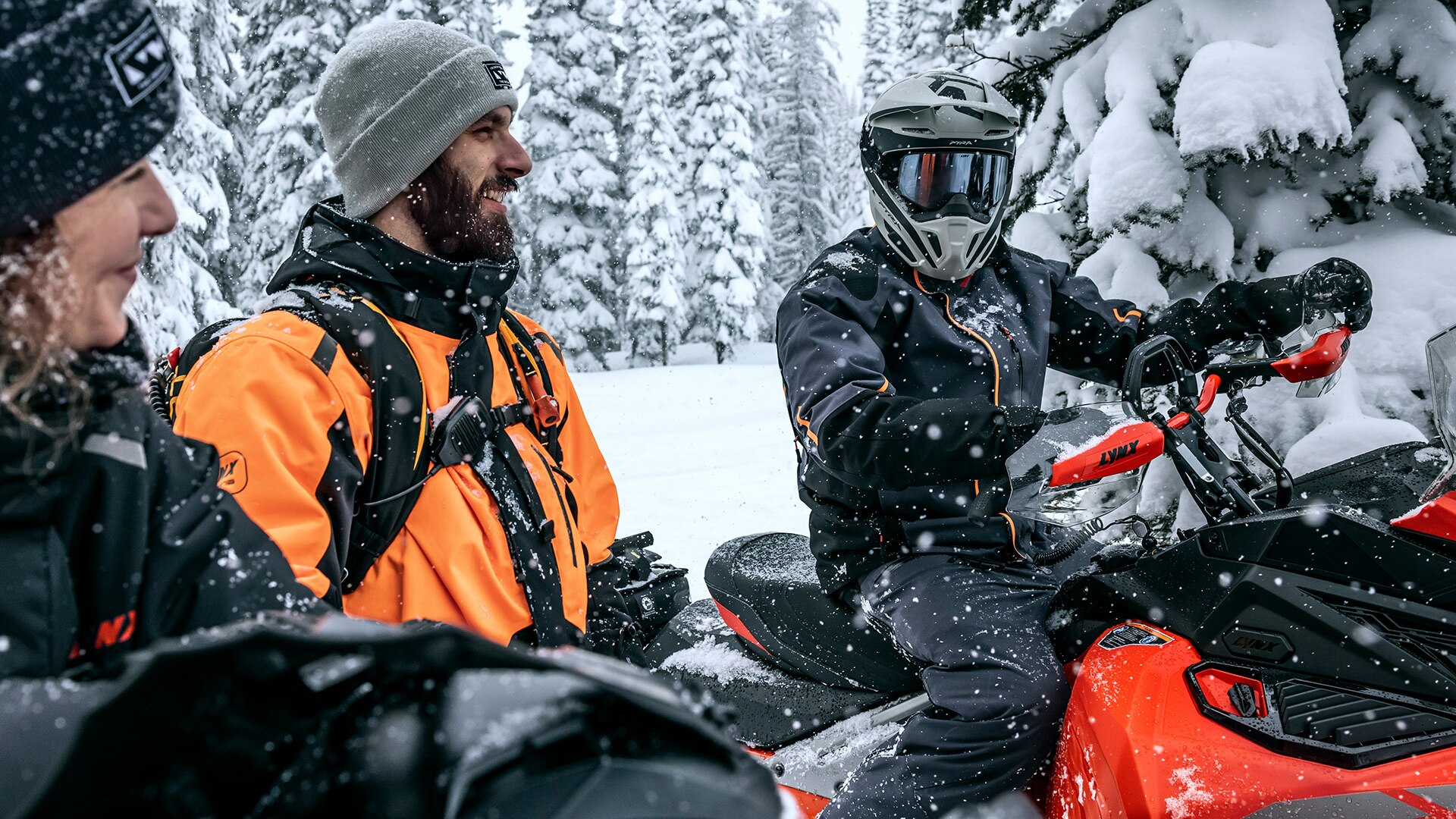 Group of Lynx riders sitting on their snowmobiles