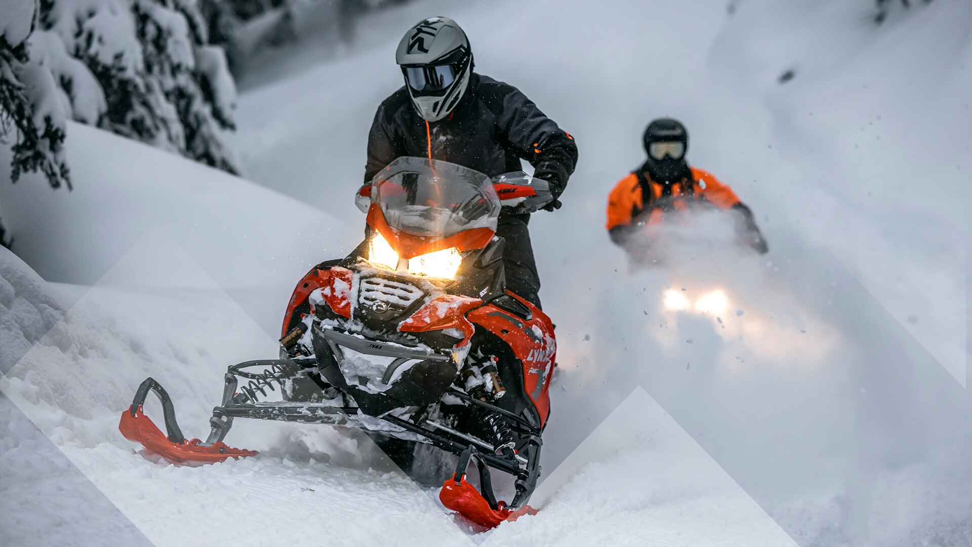 Two riders dashing through snow on their 2023 Lynx snowmobile