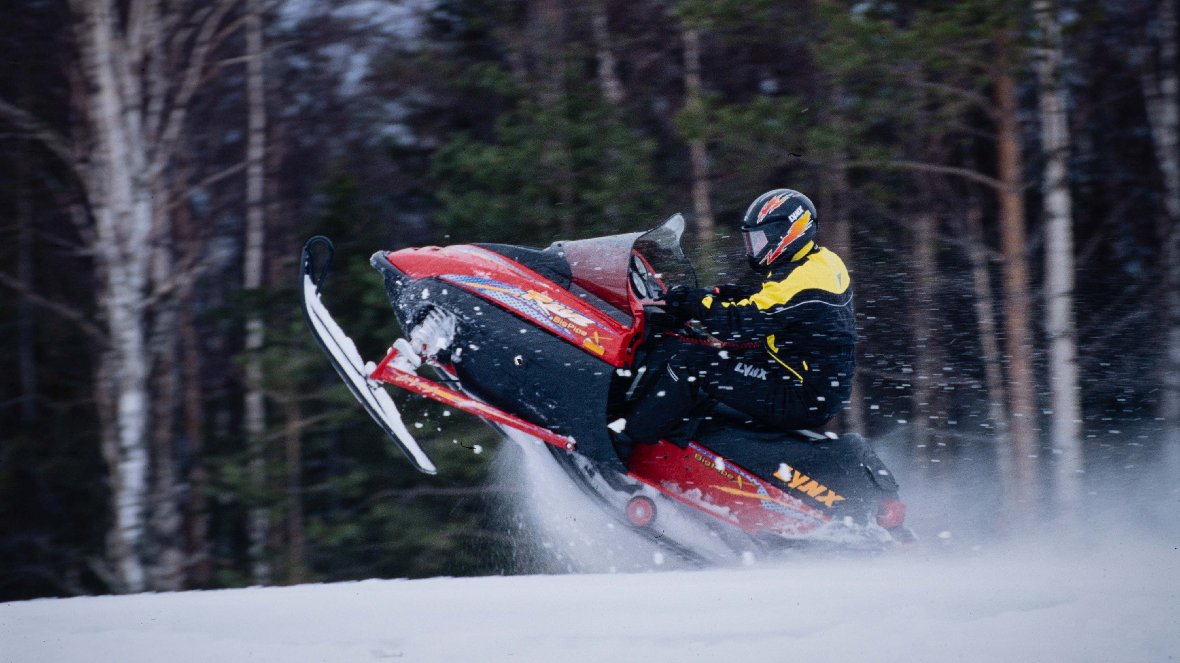 Man accelerating with Lynx Rave Big Pipe X 1999 snowmobile