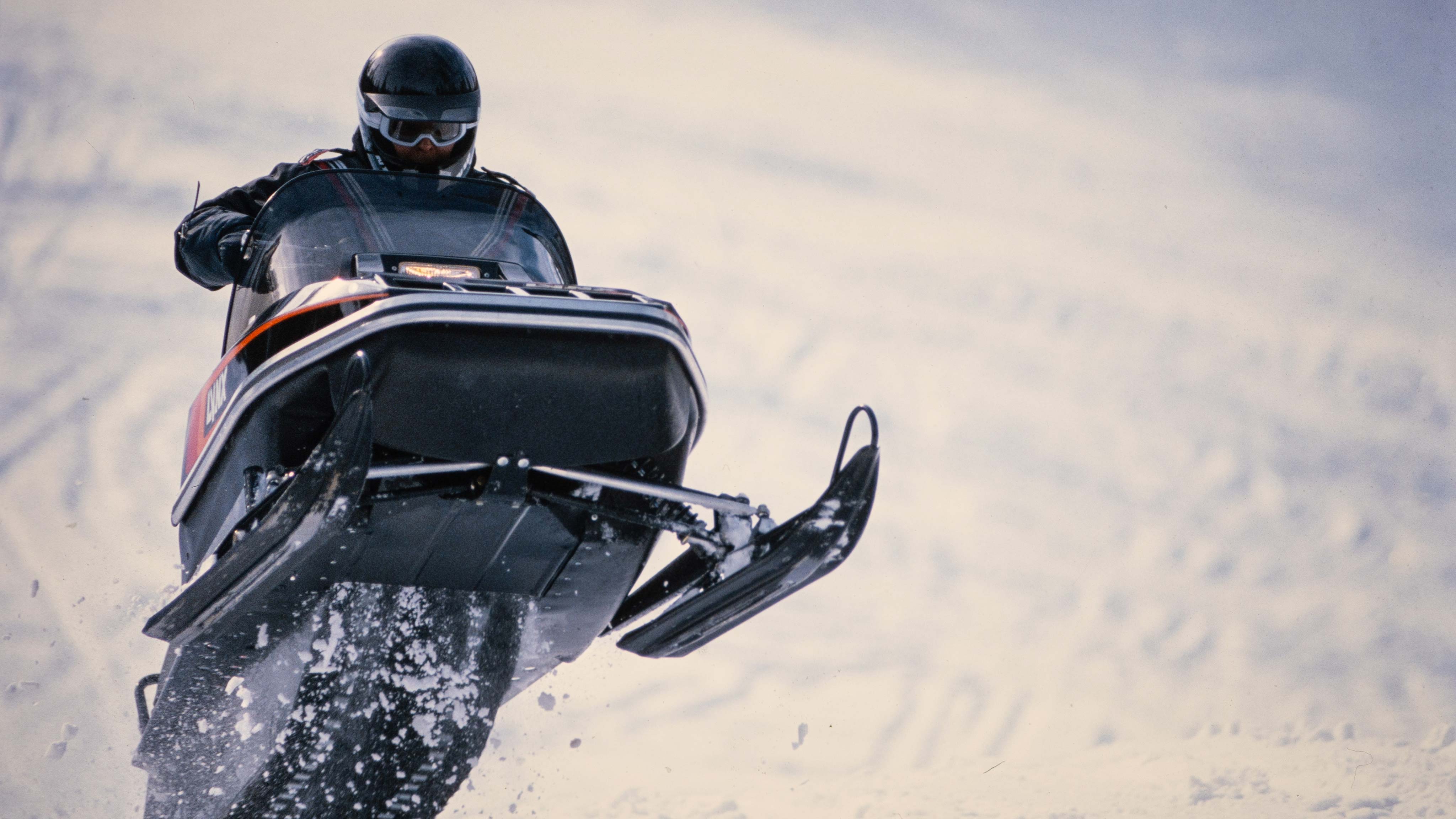 Man jumping with Lynx GLS 3300 1985 snowmobile