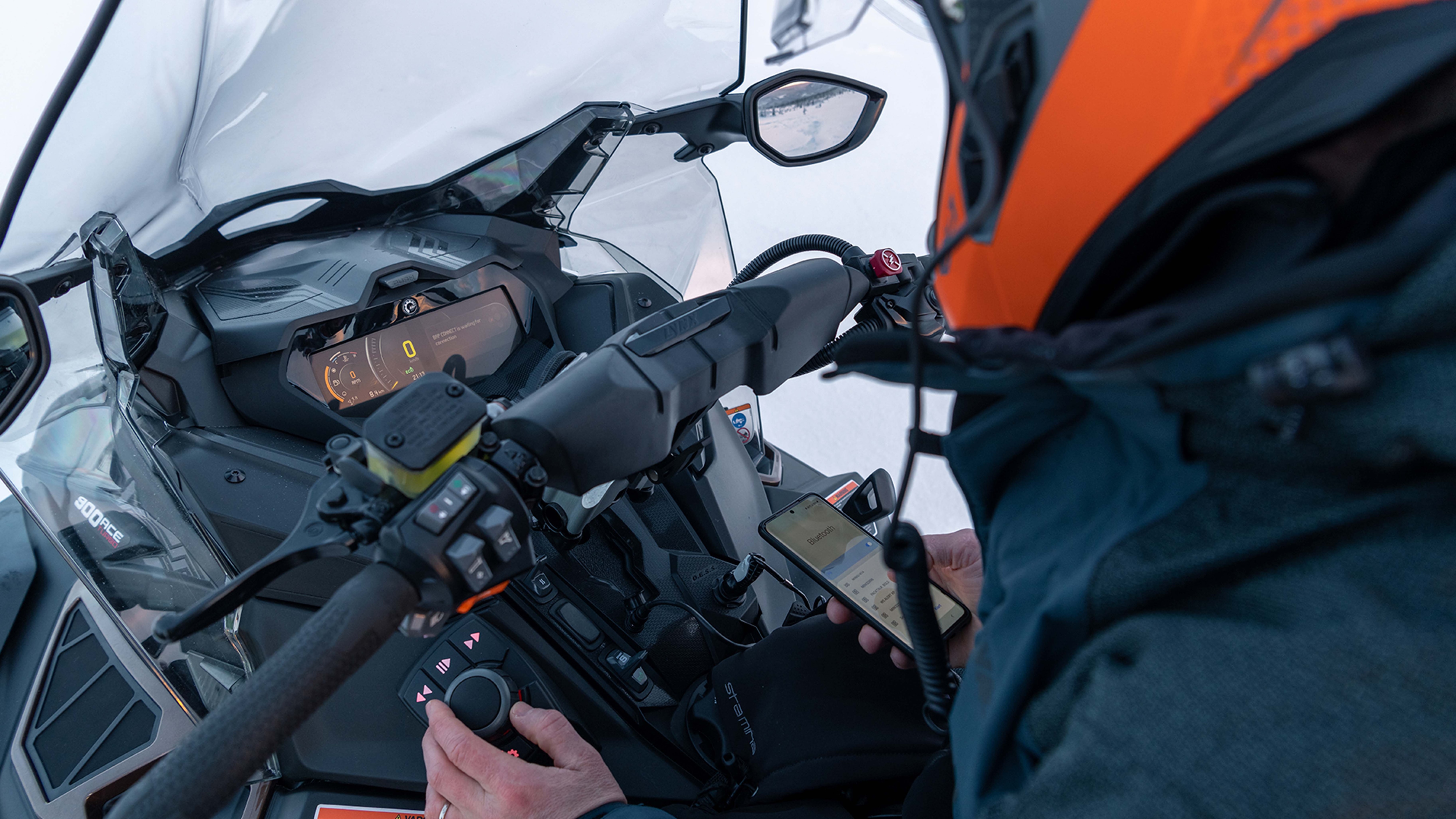 Rider using controls of Lynx Commander's digital display