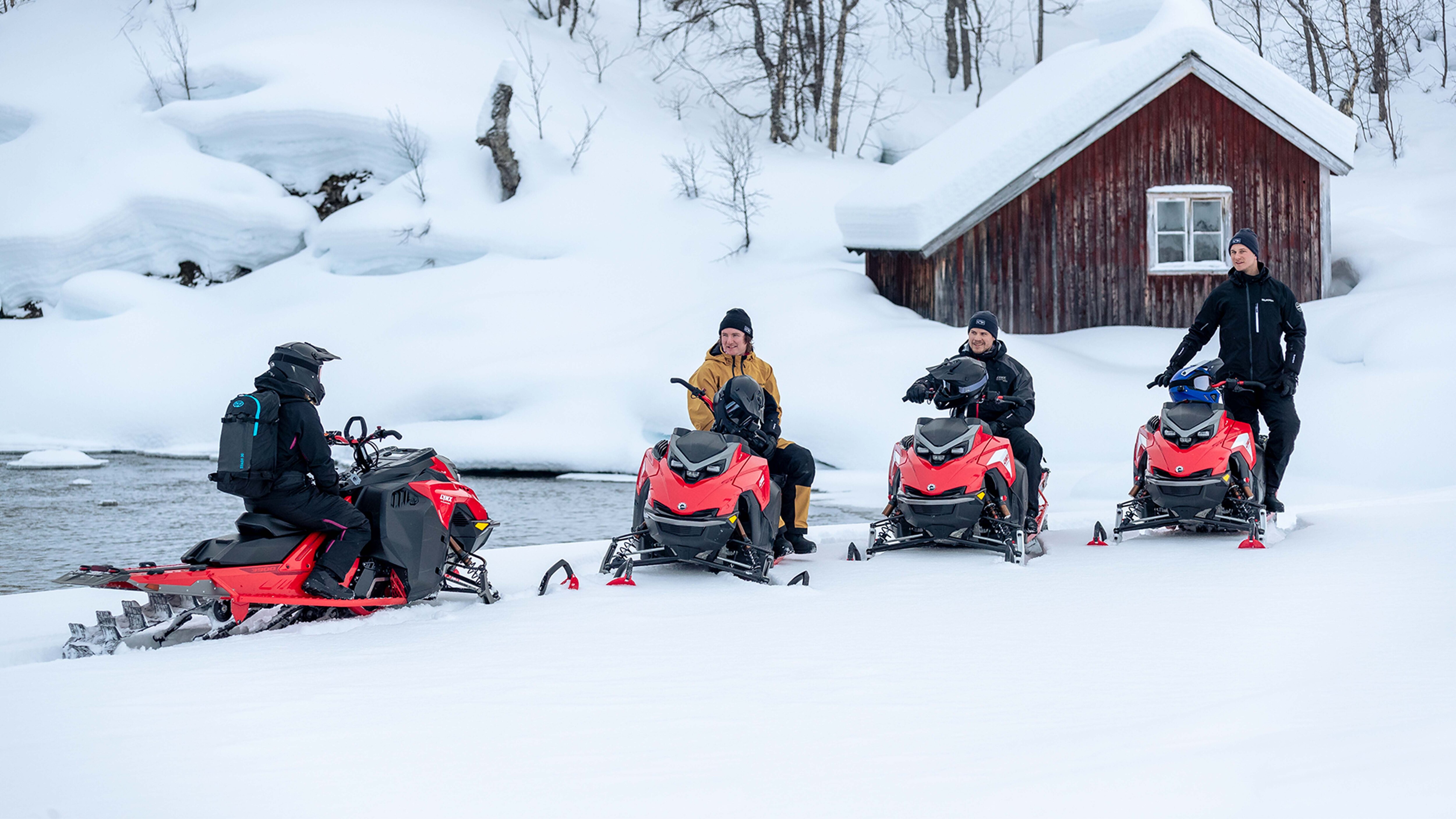Four riders chatting on Lynx Shredder 2023 snowmobiles