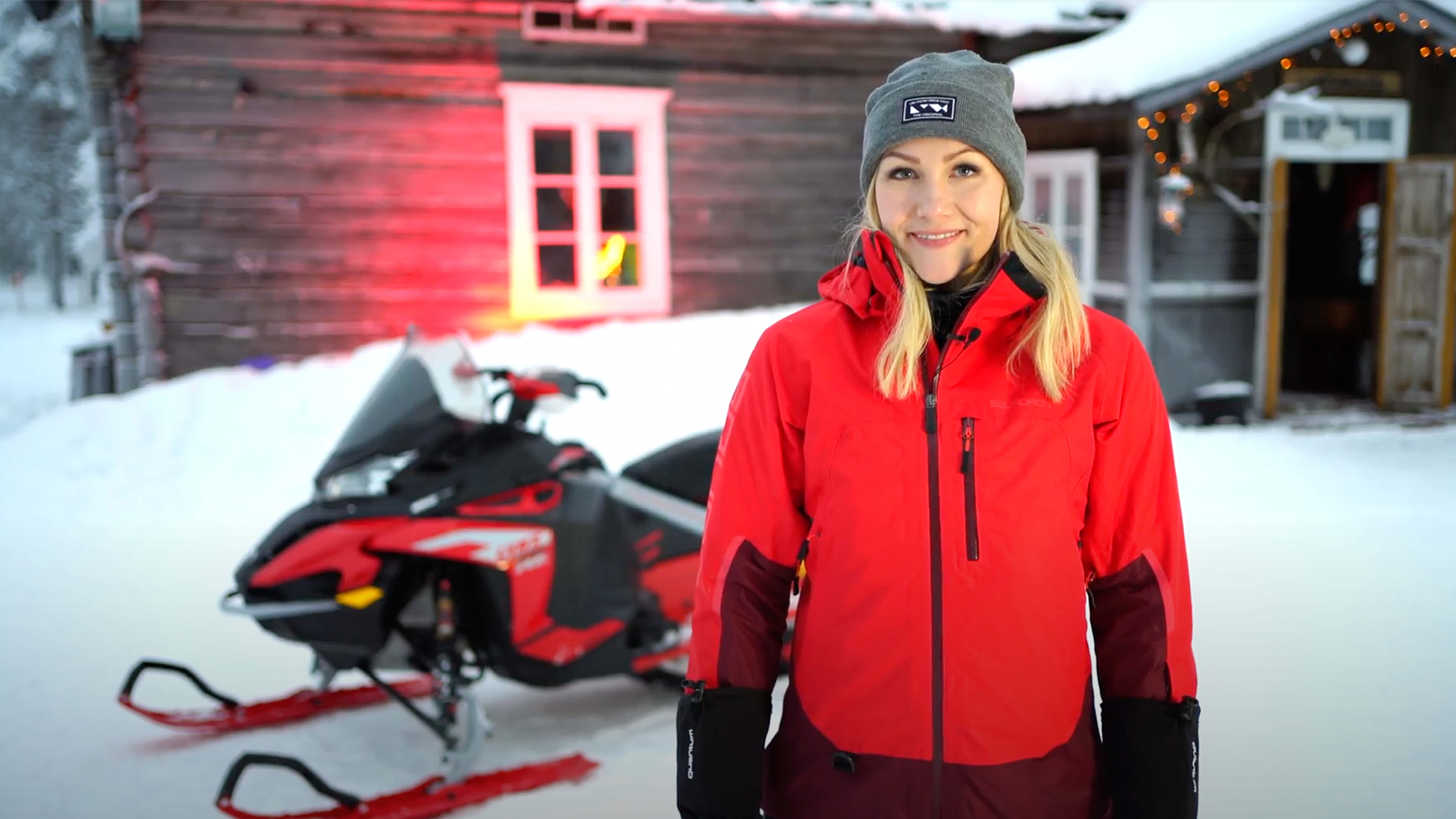 Emma Kimiläinen adjusting the chain tension of her Lynx Rave RE snowmobile
