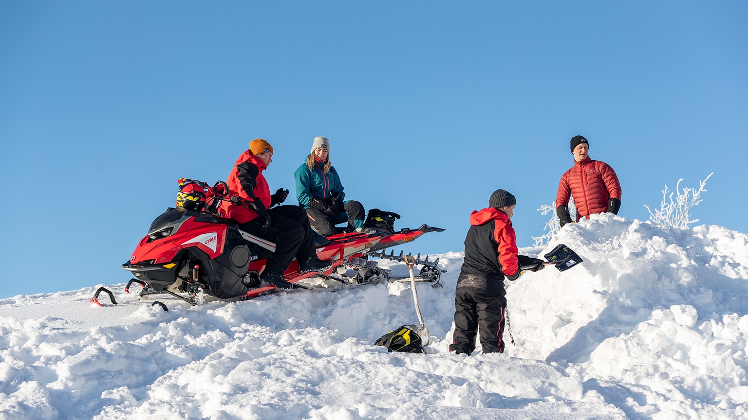 Group of Lynx riders have a break and build a jump by shovels