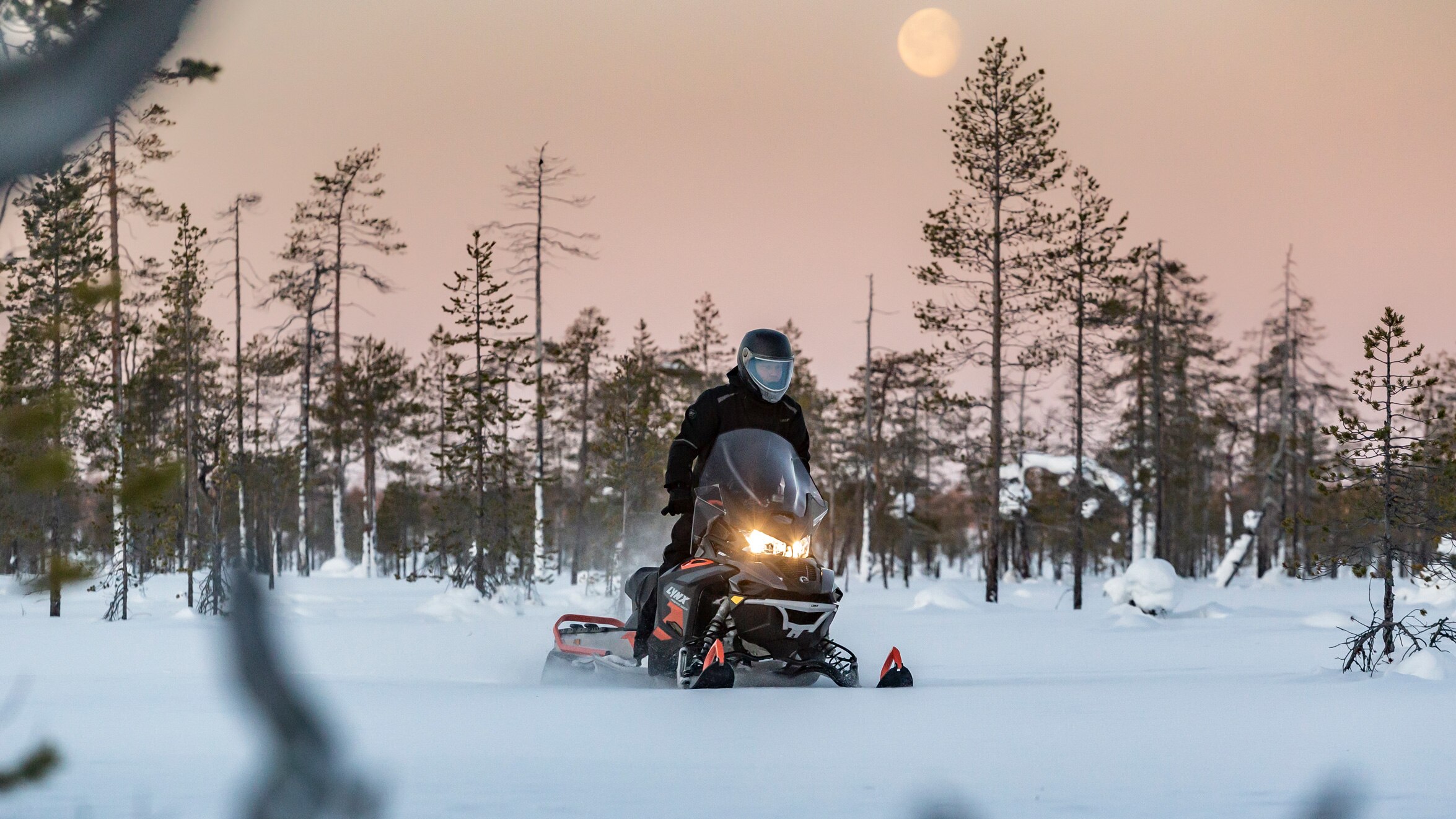 Lynx 49 Ranger PRO snowmobile riding in the forest