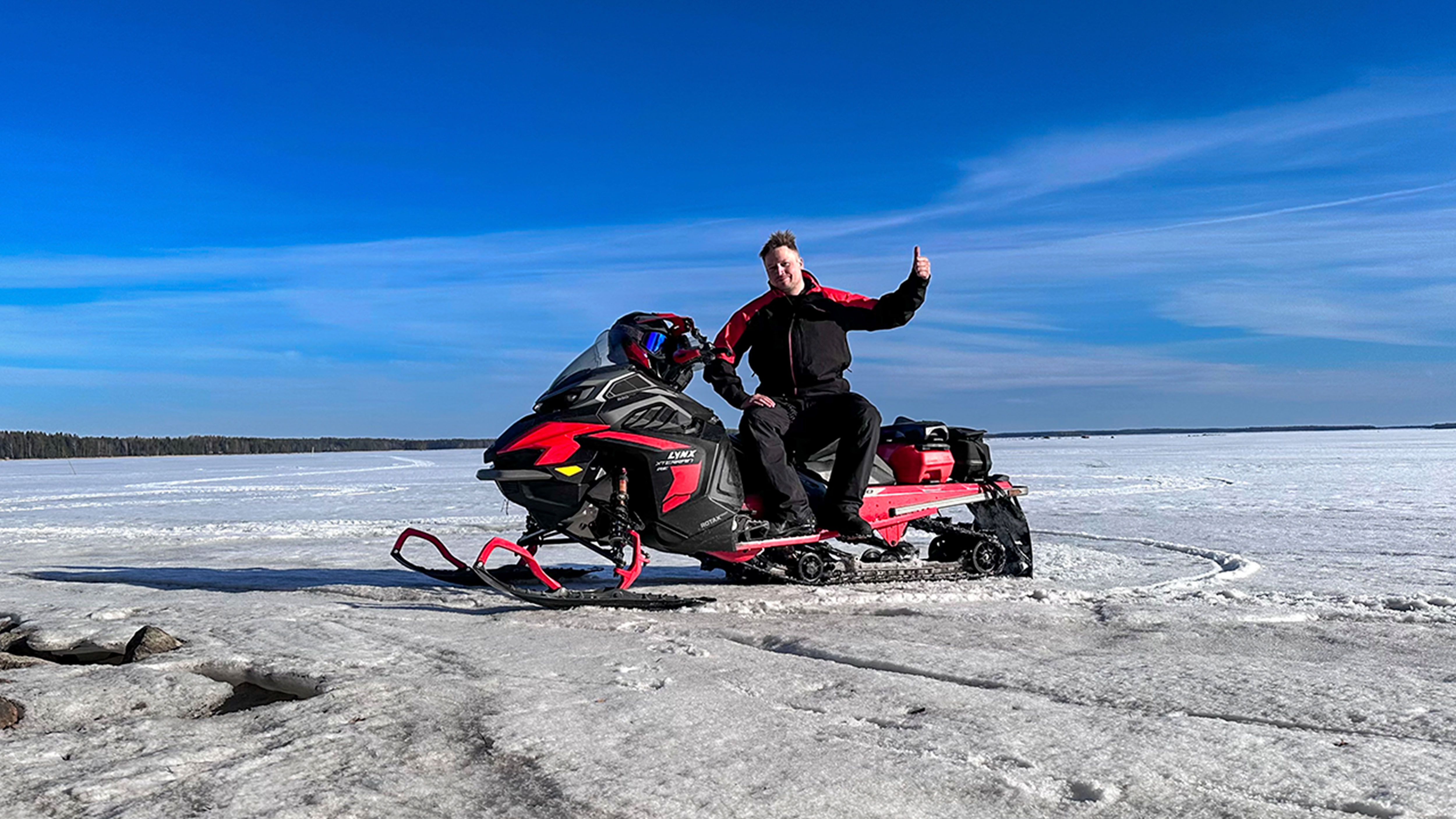 Man sitting on the Lynx Xterrain RE 850 E-TEC crossover snowmobile