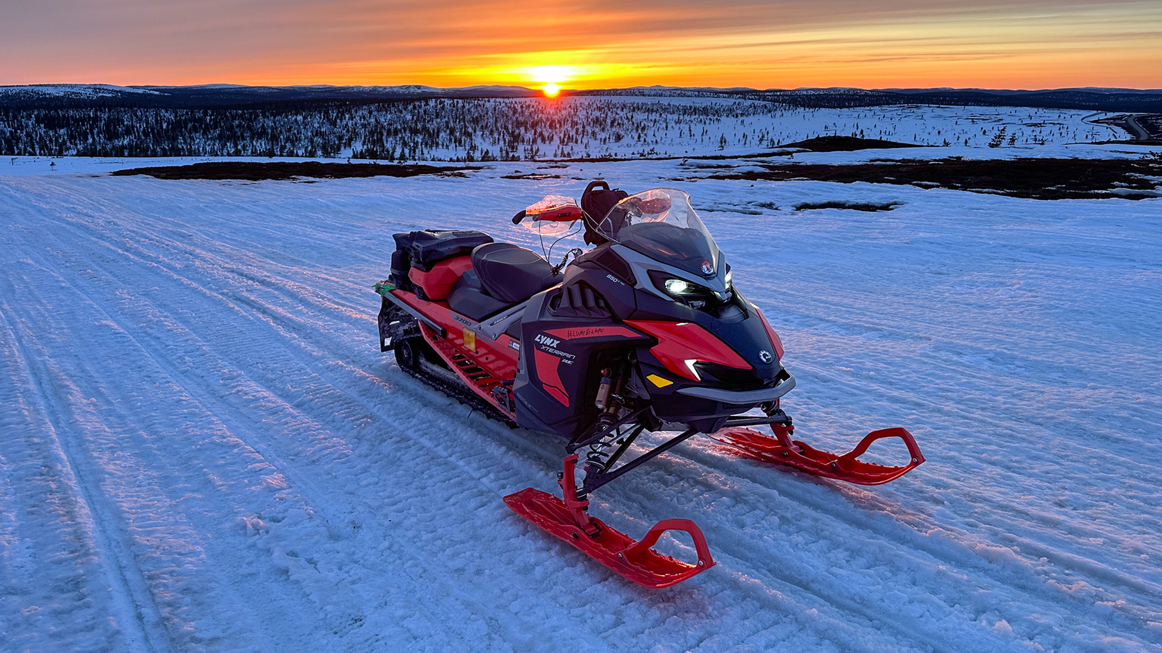 Lynx Xterrain RE 850 E-TEC crossover snowmobile parked on a trail at highlands