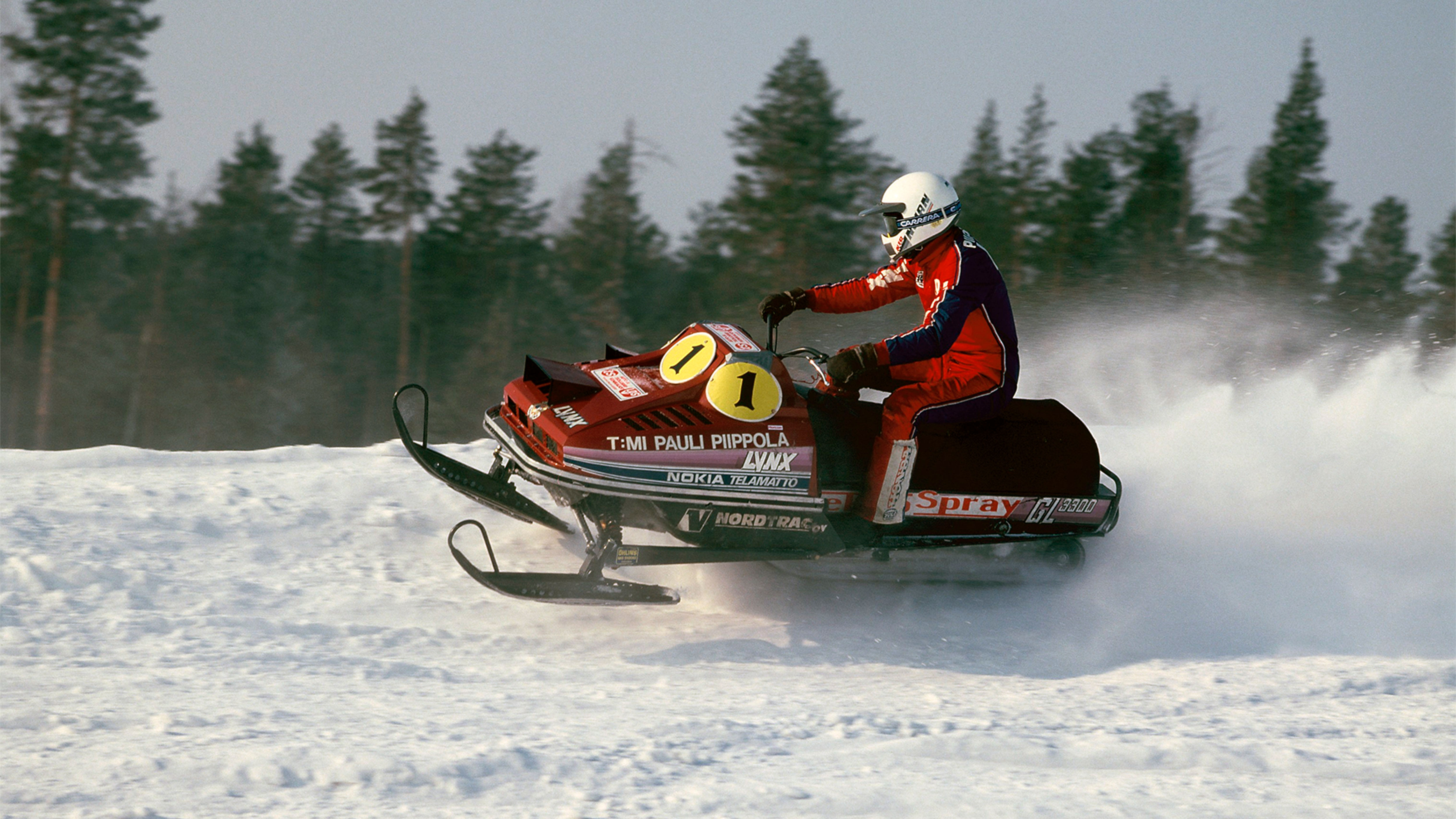 Pauli Piippola riding the first Lynx racing snowmobile on a track