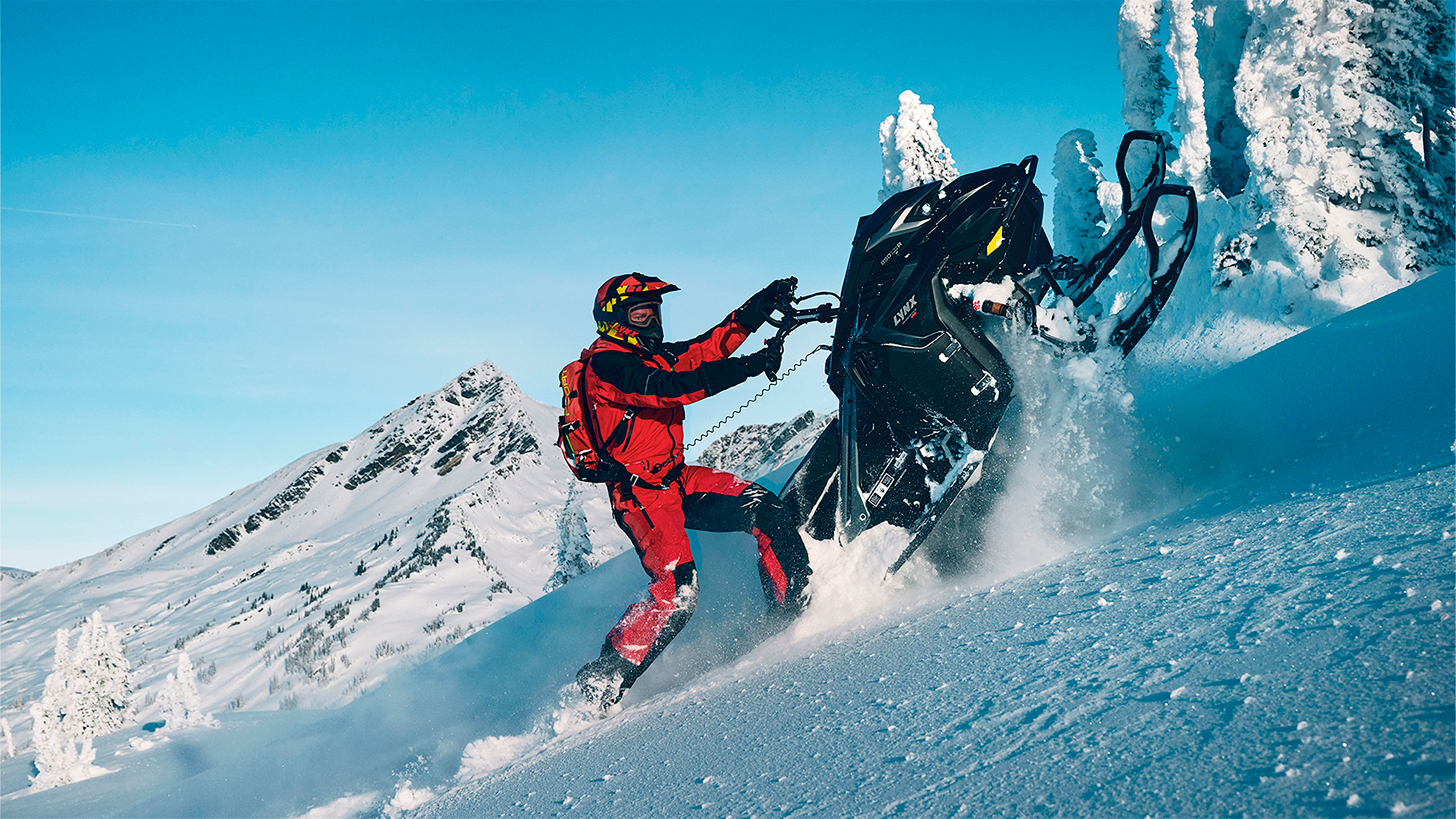 Lynx Shredder RE snowmobile making turn on mountain top