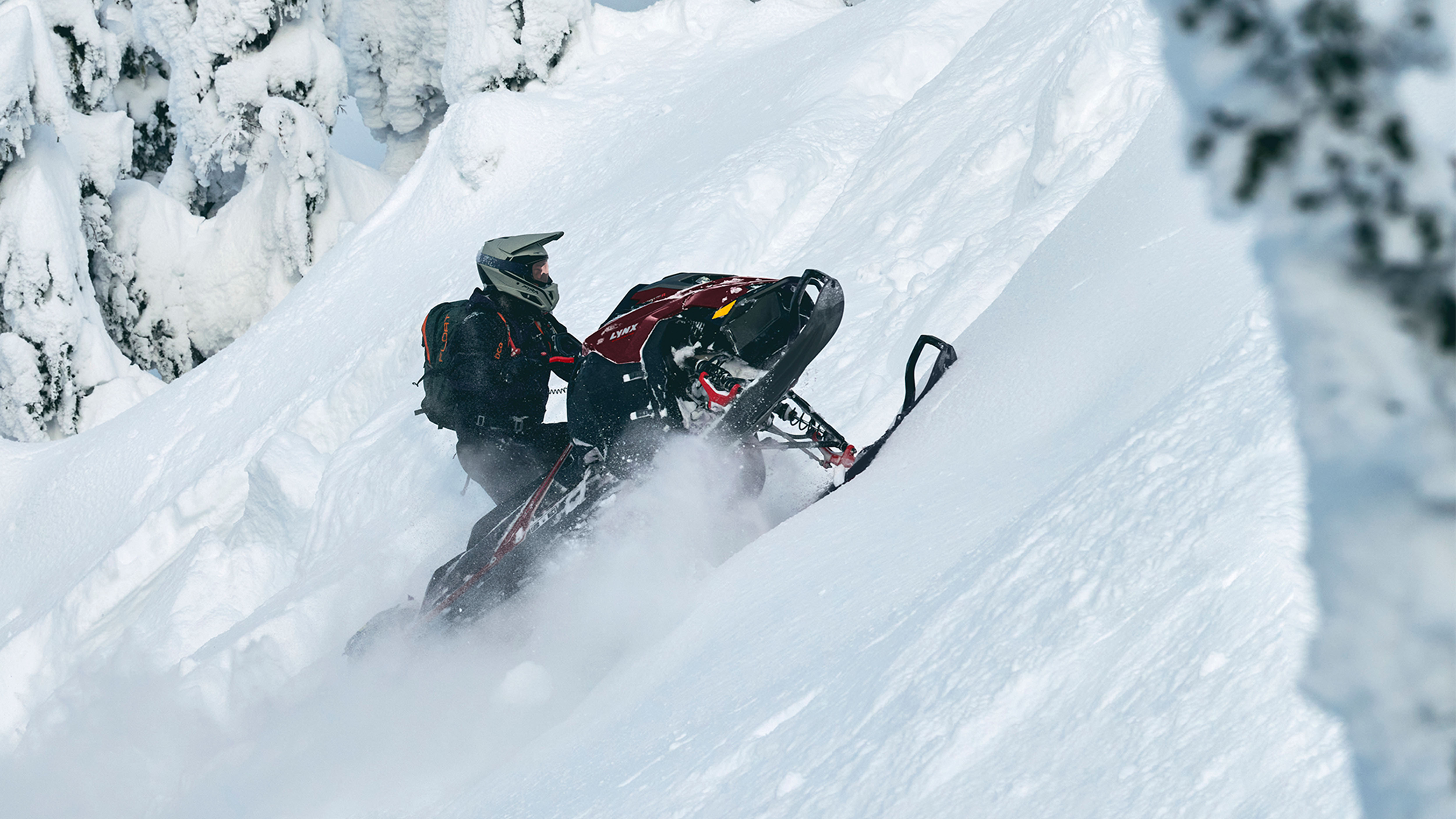 Lynx Shredder DS snowmobile climbing a steep hill