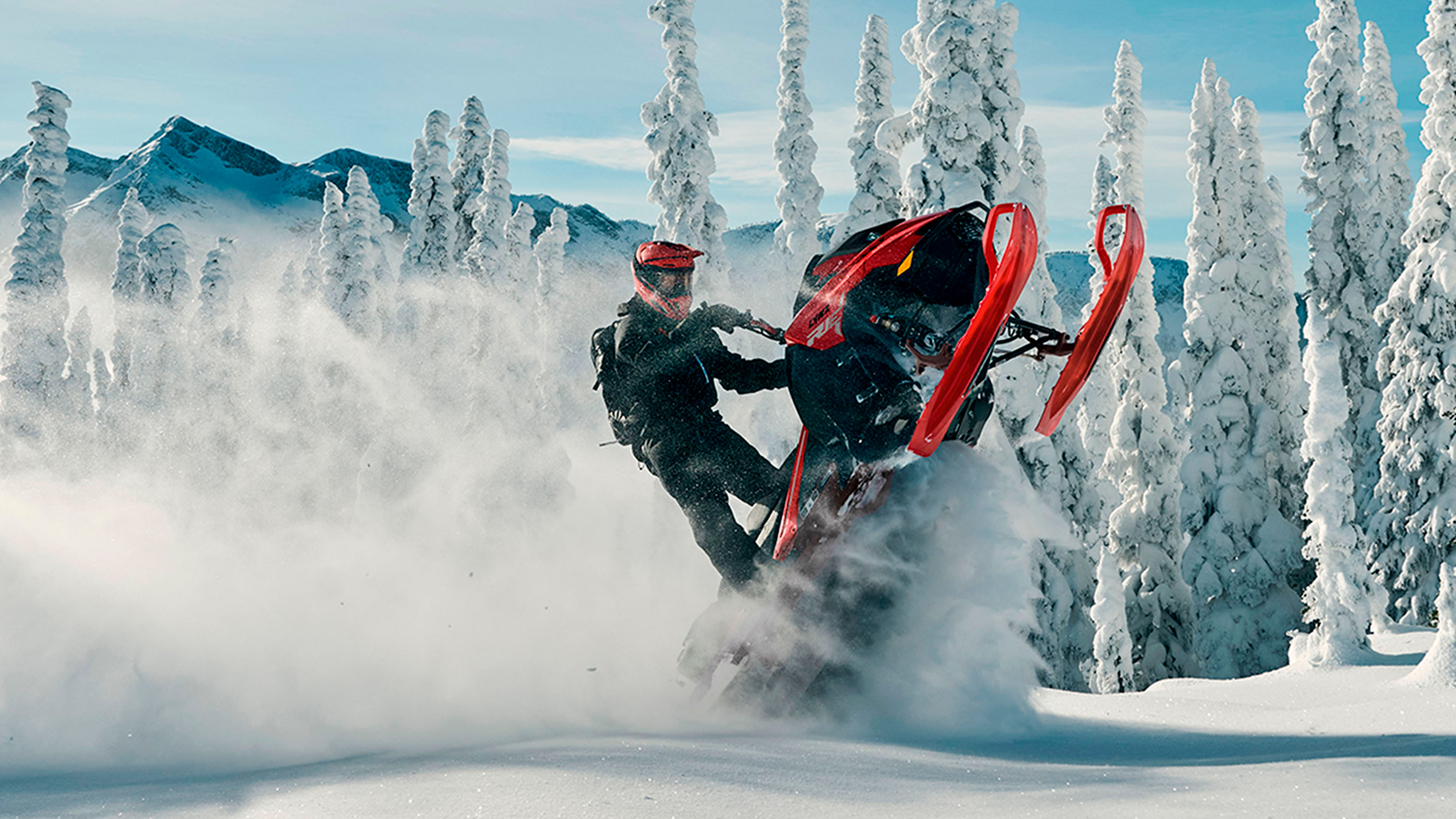 Lynx Shredder RE snowmobile lifting skis at mountains