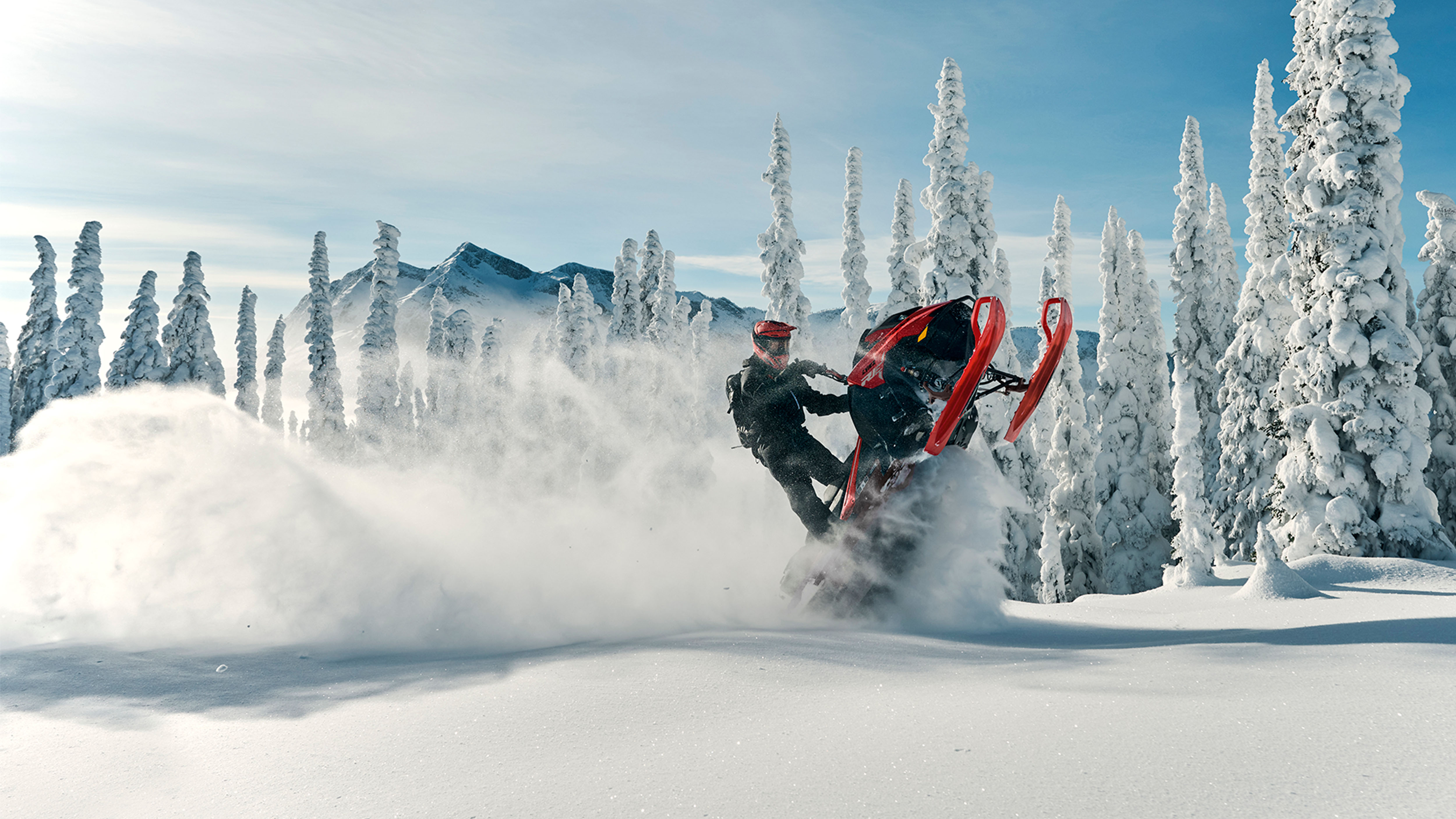 Lynx Shredder RE snowmobile lifting skis in a mountains