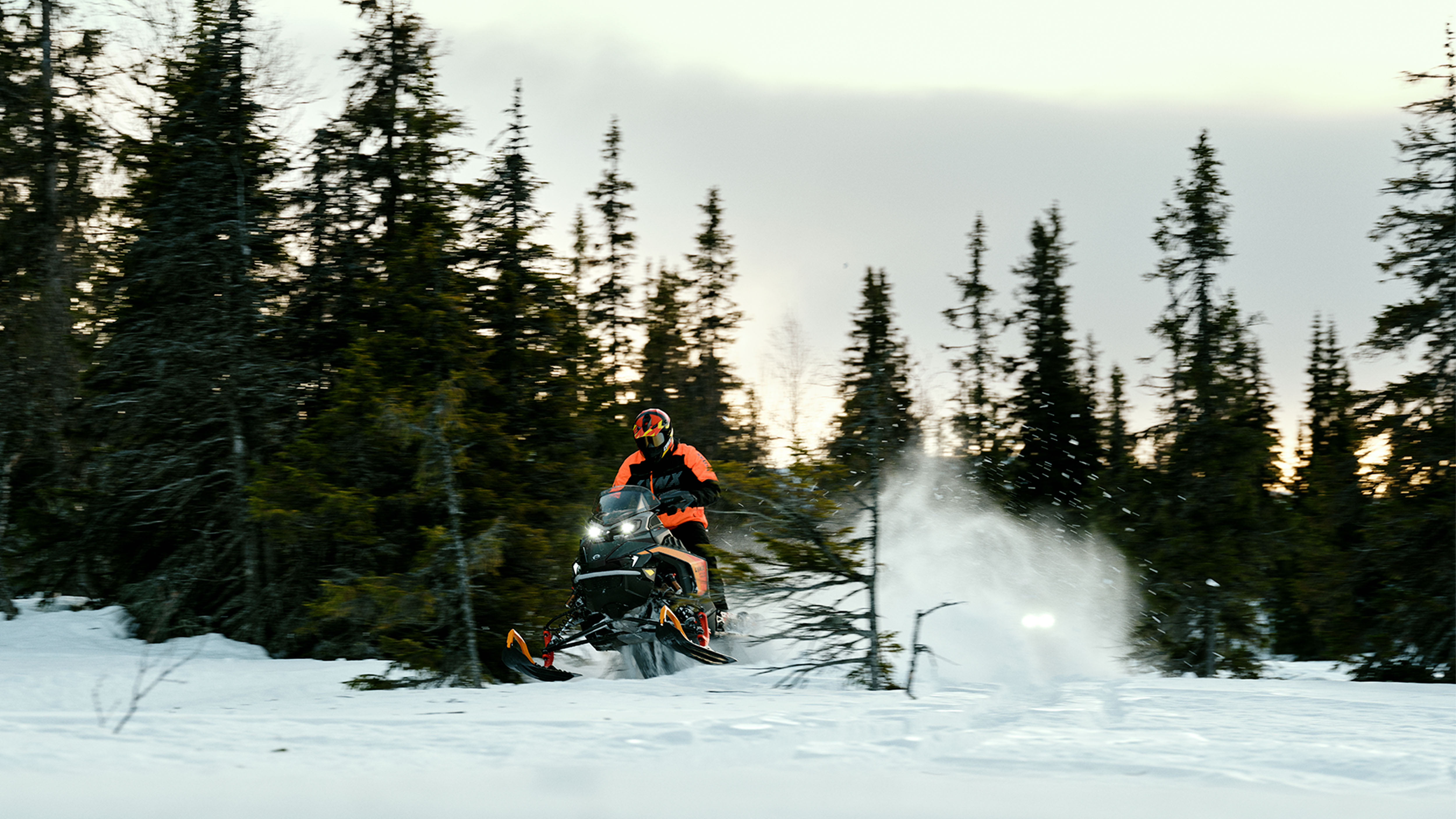 Two Lynx Rave 2025 snowmobiles riding sporty on snowy trail